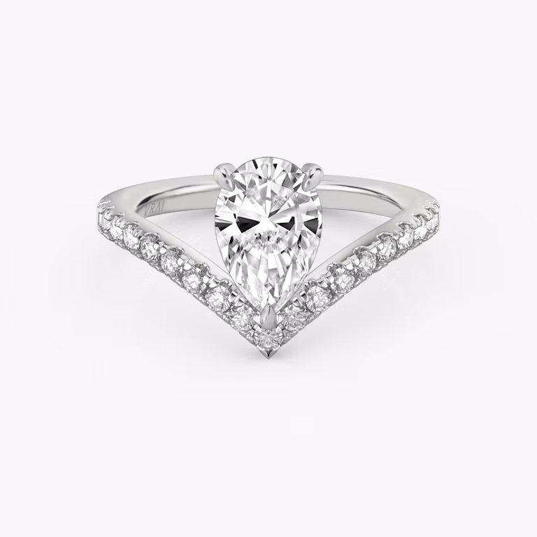 Signature V-ring with a pear-cut center stone and pavé-set accents, crafted in white gold, shown on white background.
