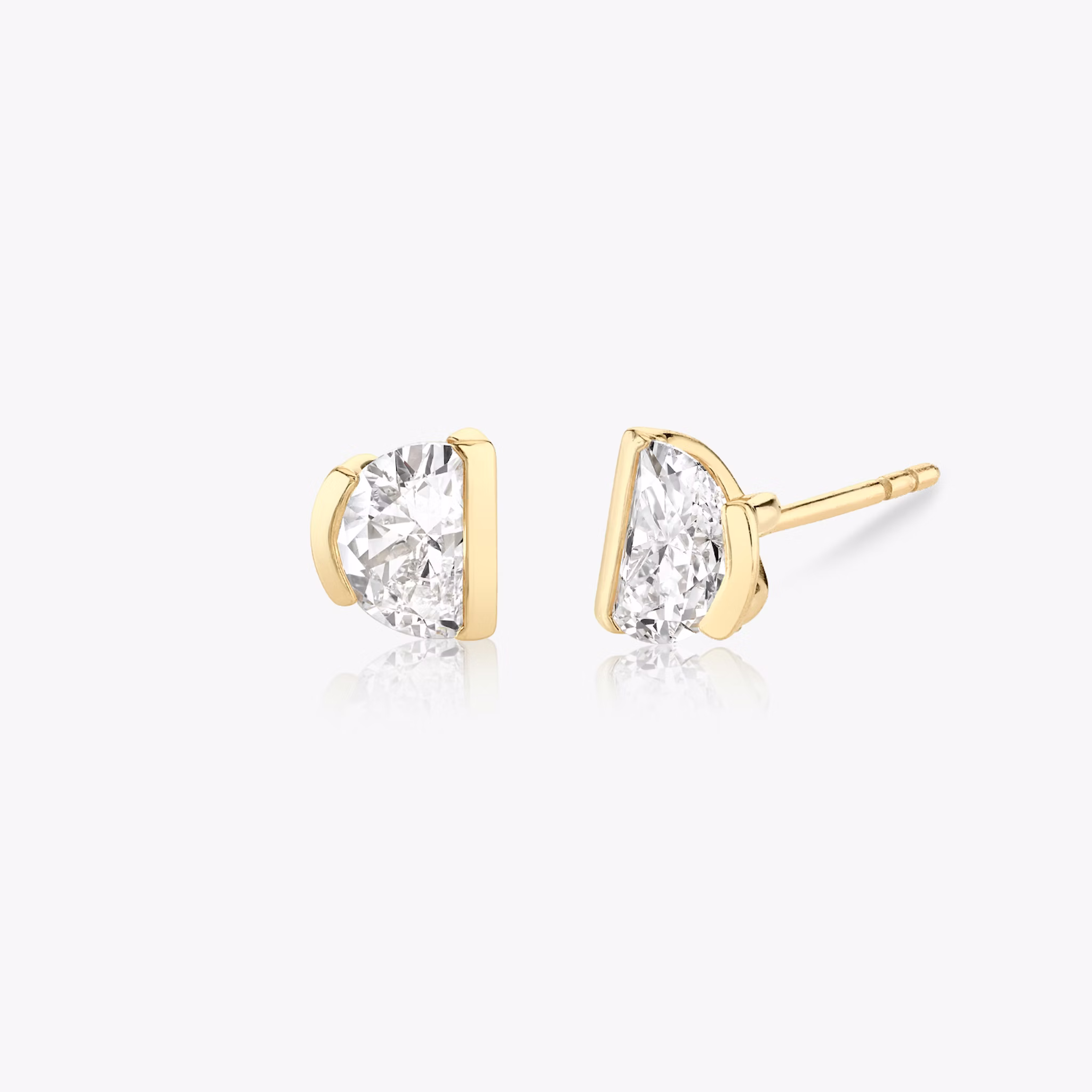 0.75ct half-moon diamond studs in yellow gold with semi-bezel setting, offering a modern asymmetrical jewelry style.