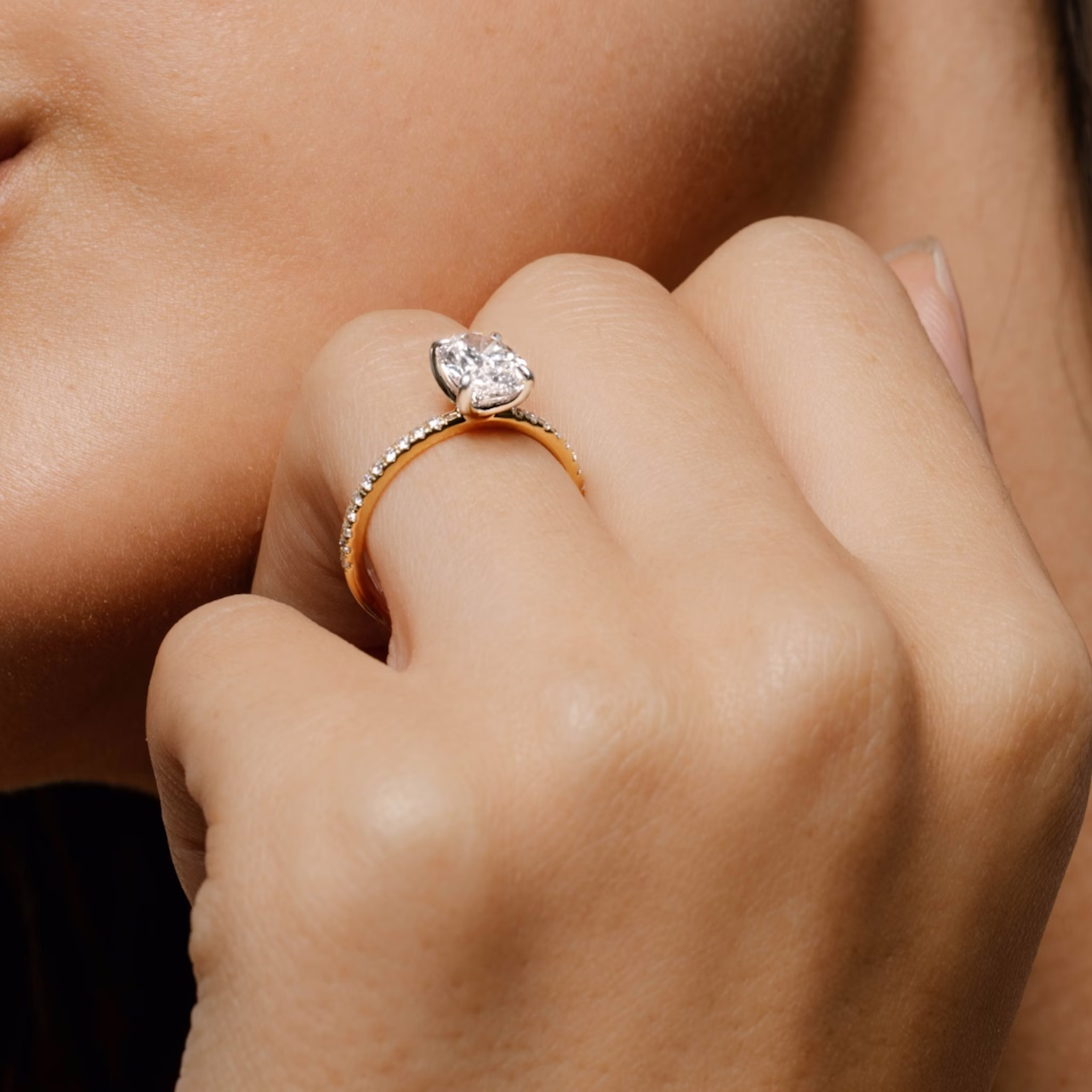 Video of an engagement ring with a pave band and two tone setting on a woman's hand