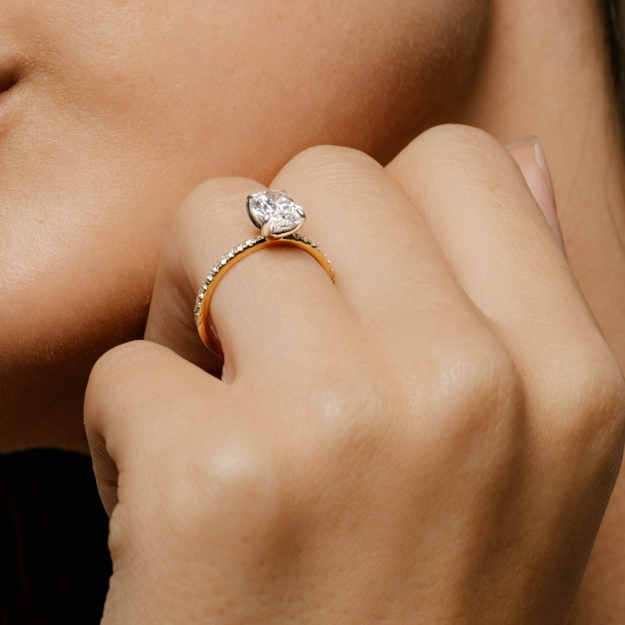 Video of an engagement ring with a pave band and two tone setting on a woman's hand