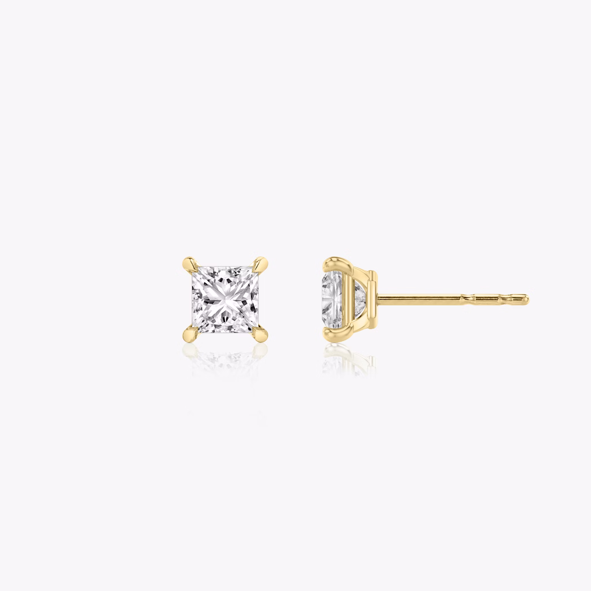 Two studs with a princess cut diamond in yellow gold side view