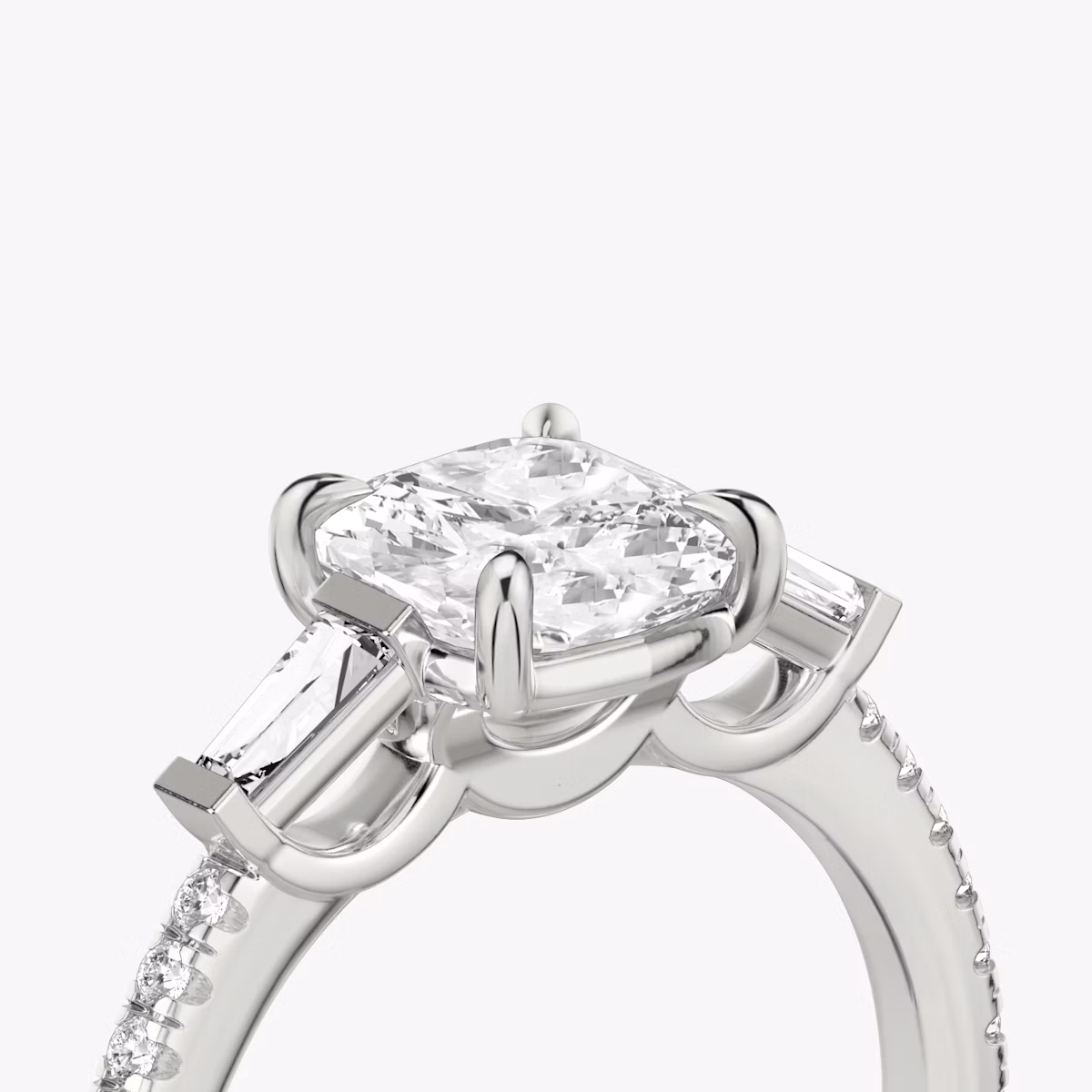 The Three Stone | Cushion | Platinum | bandAccent: Pavé | sideStoneCarat: 0.10ct | sideStoneShape: Tapered Baguette | diamondOrientation: vertical | caratWeight: other