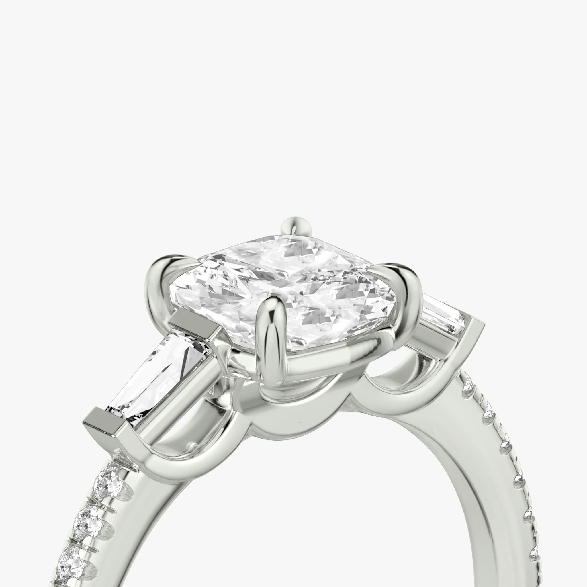 The Three Stone | Cushion | 18k | White Gold | bandAccent: Pavé | sideStoneCarat: 0.10ct | sideStoneShape: Tapered Baguette | diamondOrientation: vertical | caratWeight: other