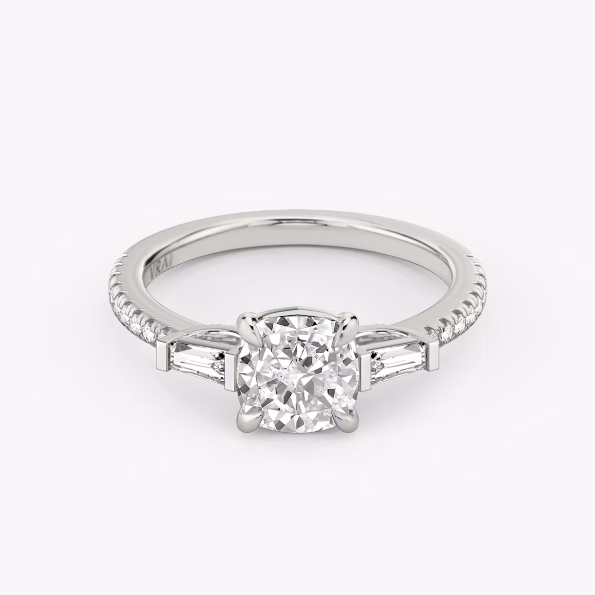 The Three Stone | Cushion | Platinum | bandAccent: Pavé | sideStoneCarat: 0.10ct | sideStoneShape: Tapered Baguette | diamondOrientation: vertical | caratWeight: other