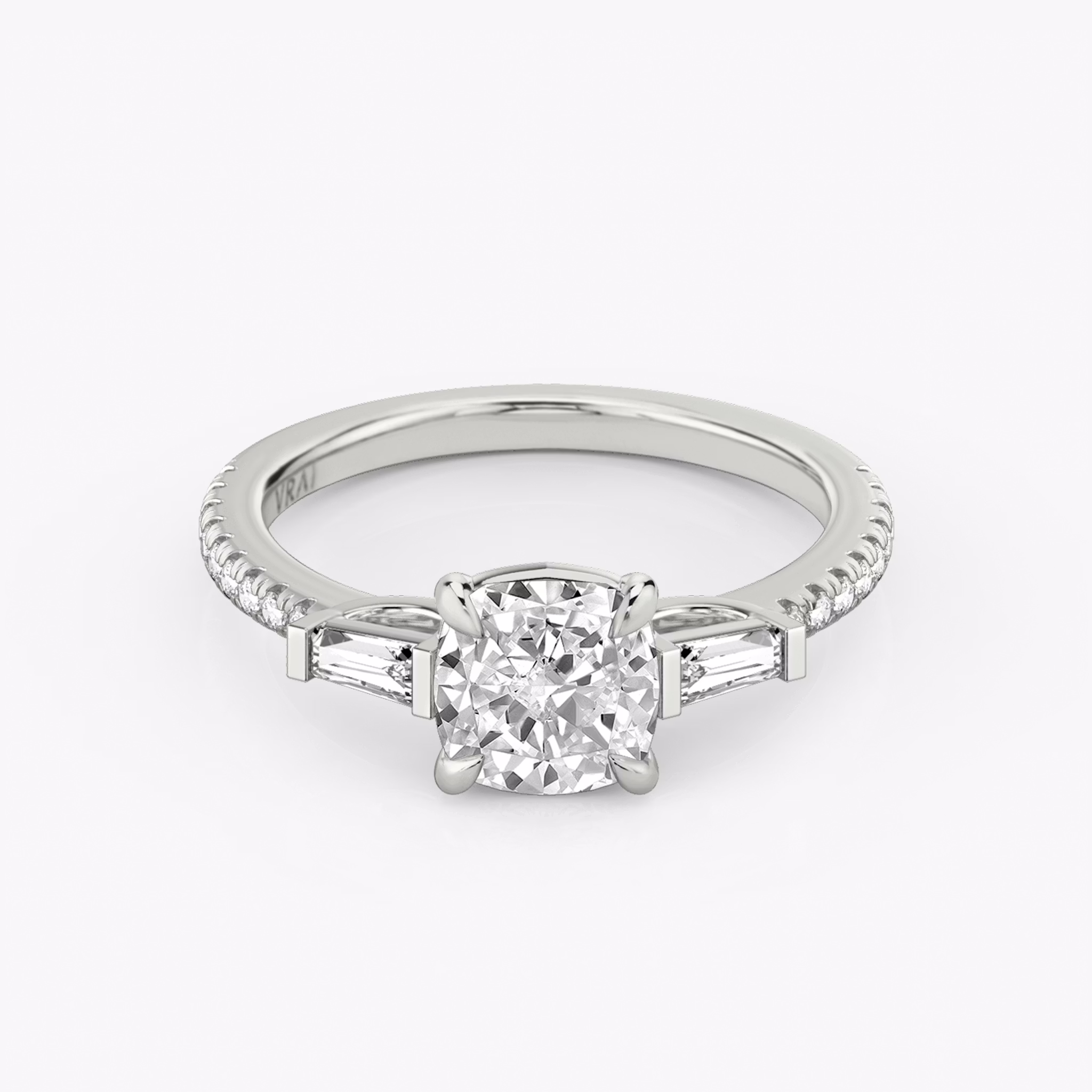 The Three Stone | Cushion | 18k | White Gold | bandAccent: Pavé | sideStoneCarat: 0.10ct | sideStoneShape: Tapered Baguette | diamondOrientation: vertical | caratWeight: other