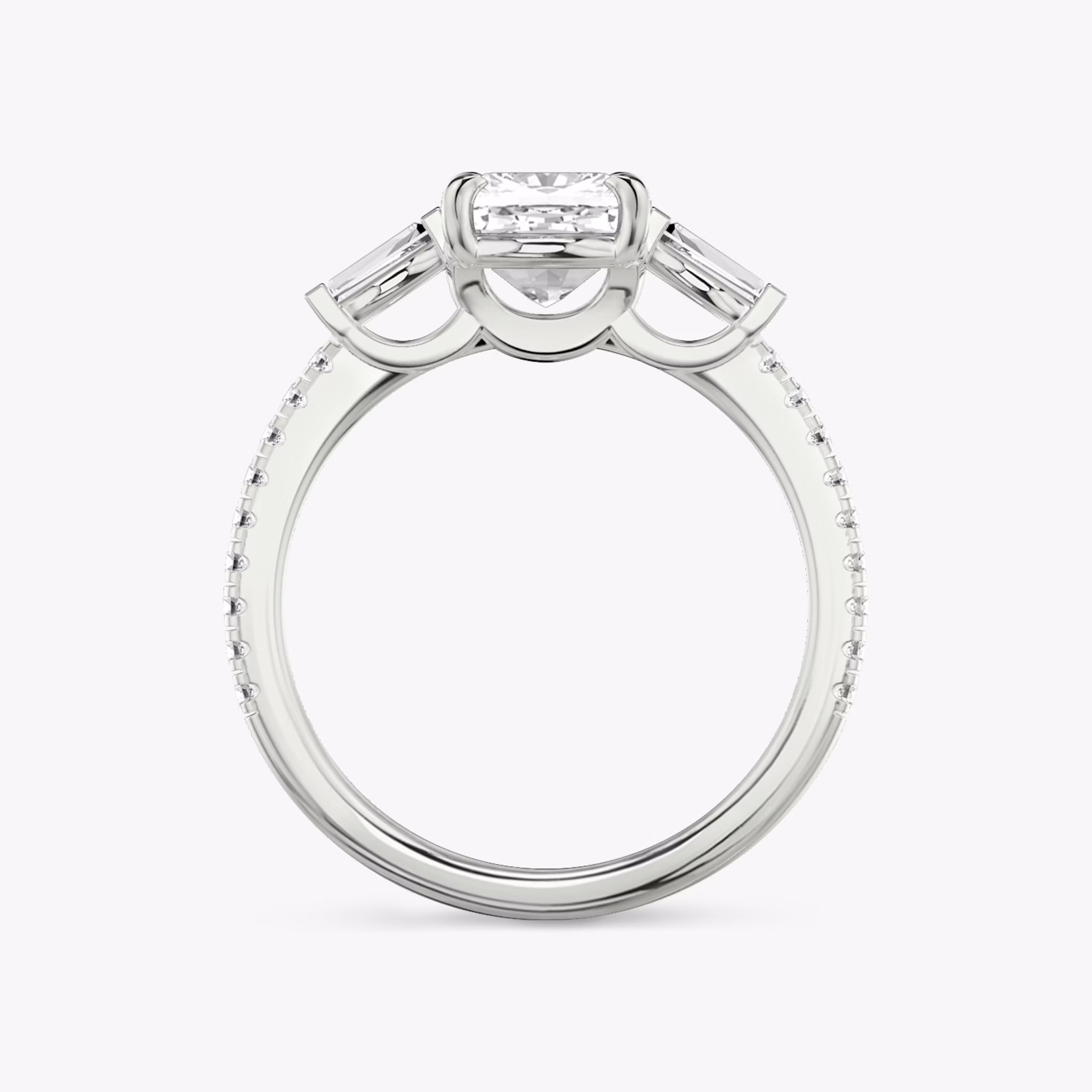 The Three Stone | Cushion | 18k | White Gold | bandAccent: Pavé | sideStoneCarat: 0.10ct | sideStoneShape: Tapered Baguette | diamondOrientation: vertical | caratWeight: other