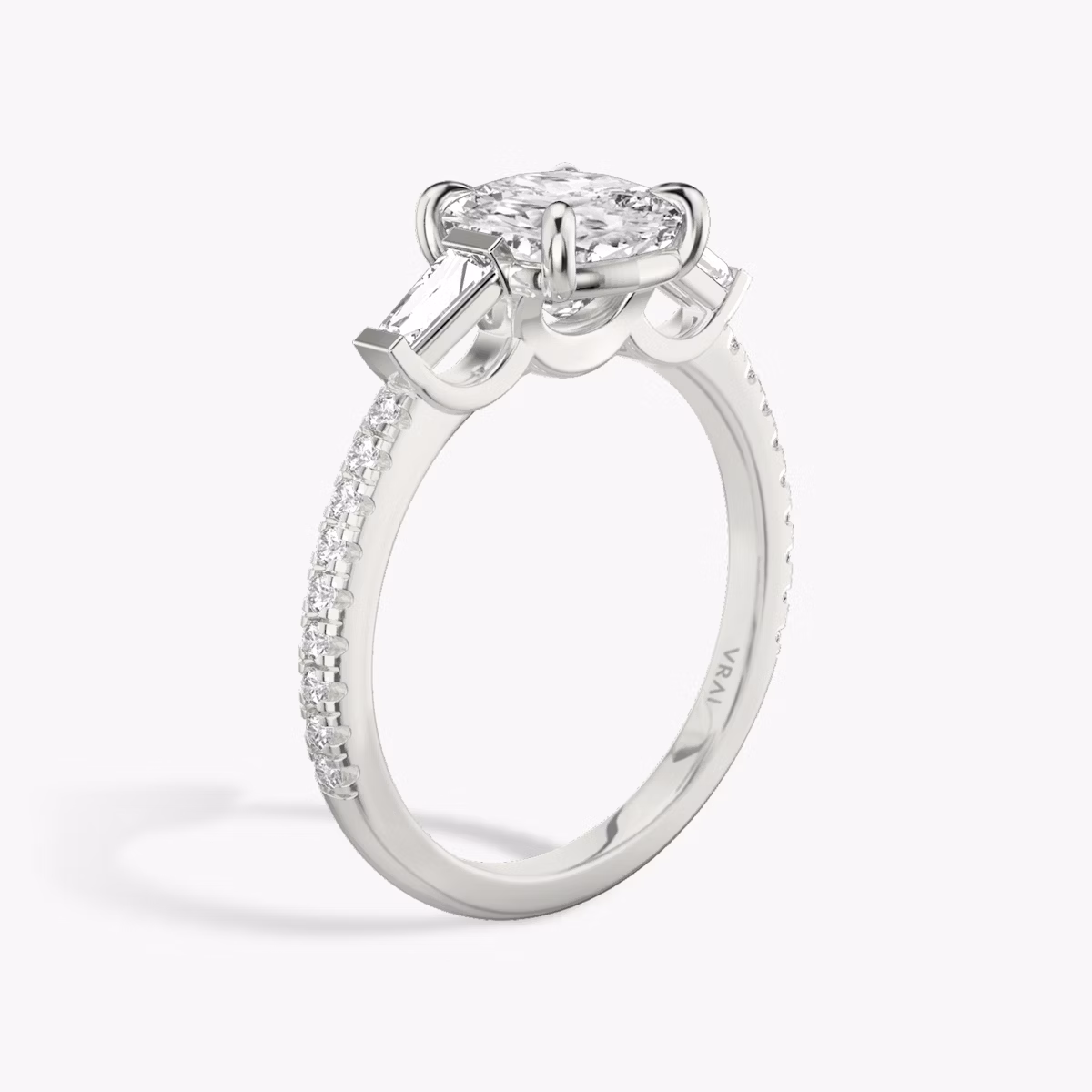 The Three Stone | Cushion | Platinum | bandAccent: Pavé | sideStoneCarat: 0.10ct | sideStoneShape: Tapered Baguette | diamondOrientation: vertical | caratWeight: other