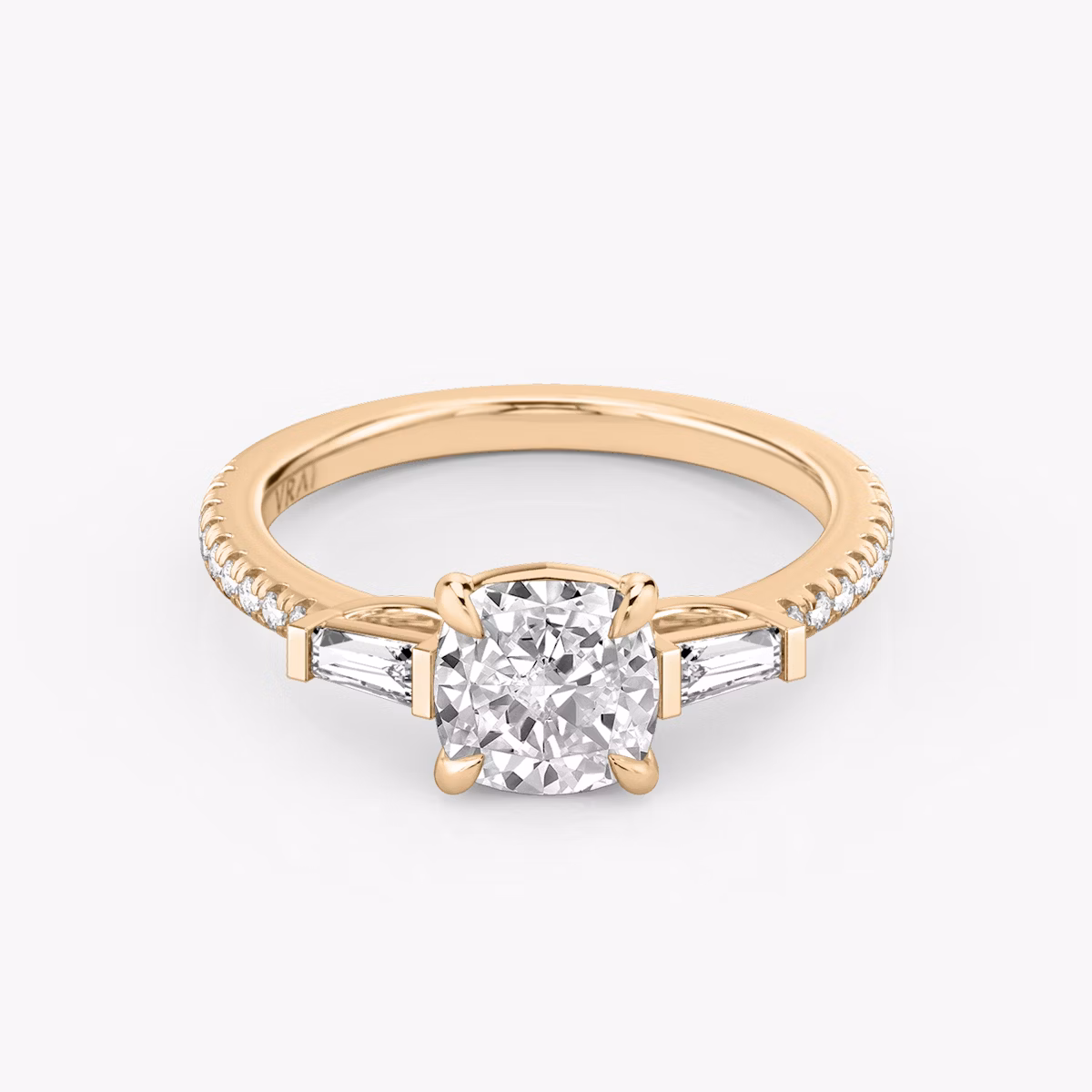 The Three Stone | Cushion | 14k | Rose Gold | bandAccent: Pavé | sideStoneCarat: 0.10ct | sideStoneShape: Tapered Baguette | diamondOrientation: vertical | caratWeight: other
