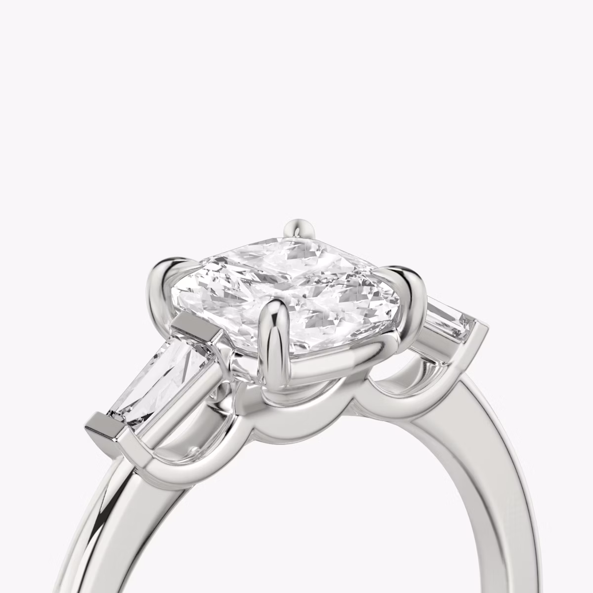 The Three Stone | Cushion | Platinum | bandAccent: Plain | sideStoneCarat: 0.10ct | sideStoneShape: Tapered Baguette | diamondOrientation: vertical | caratWeight: other
