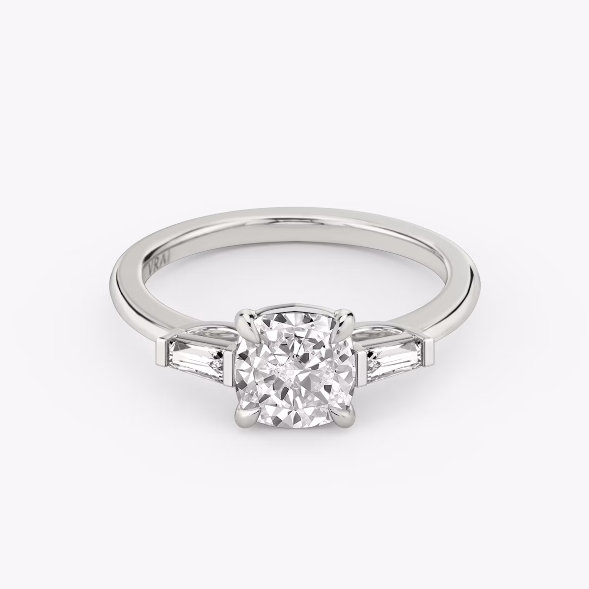 The Three Stone | Cushion | Platinum | bandAccent: Plain | sideStoneCarat: 0.10ct | sideStoneShape: Tapered Baguette | diamondOrientation: vertical | caratWeight: other