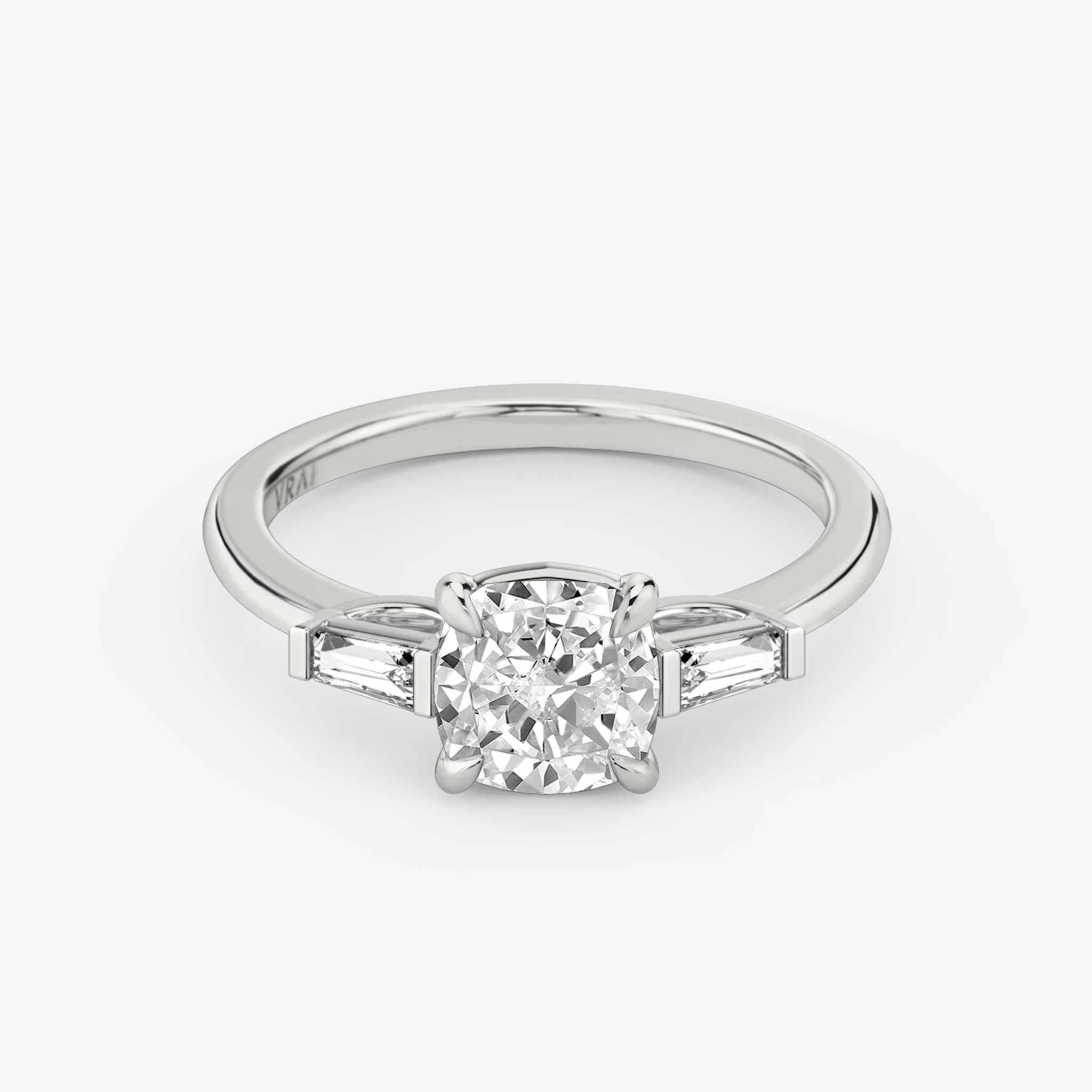 The Three Stone | Cushion | 18k | White Gold | bandAccent: Plain | sideStoneCarat: 0.10ct | sideStoneShape: Tapered Baguette | diamondOrientation: vertical | caratWeight: other