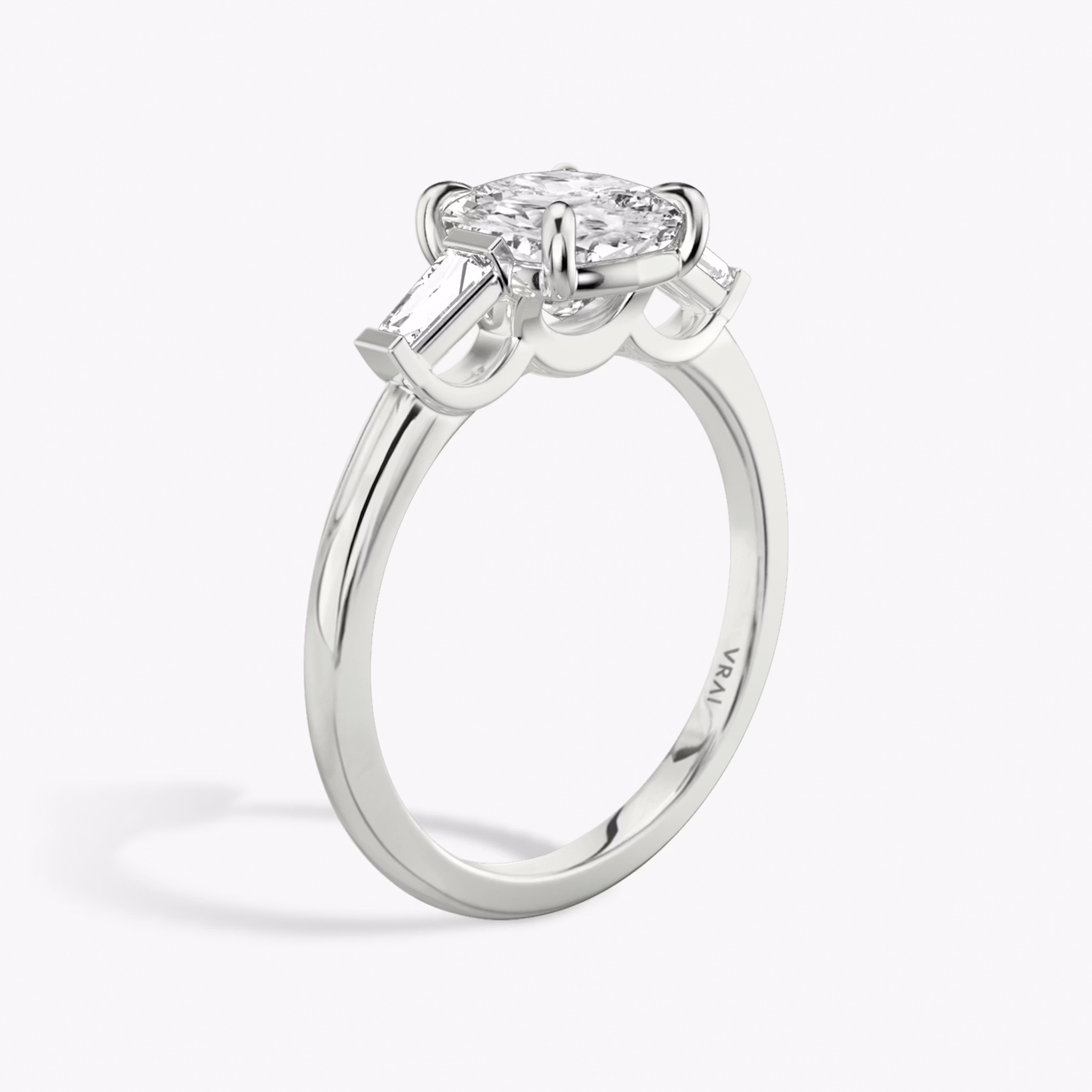 The Three Stone | Cushion | 18k | White Gold | bandAccent: Plain | sideStoneCarat: 0.10ct | sideStoneShape: Tapered Baguette | diamondOrientation: vertical | caratWeight: other