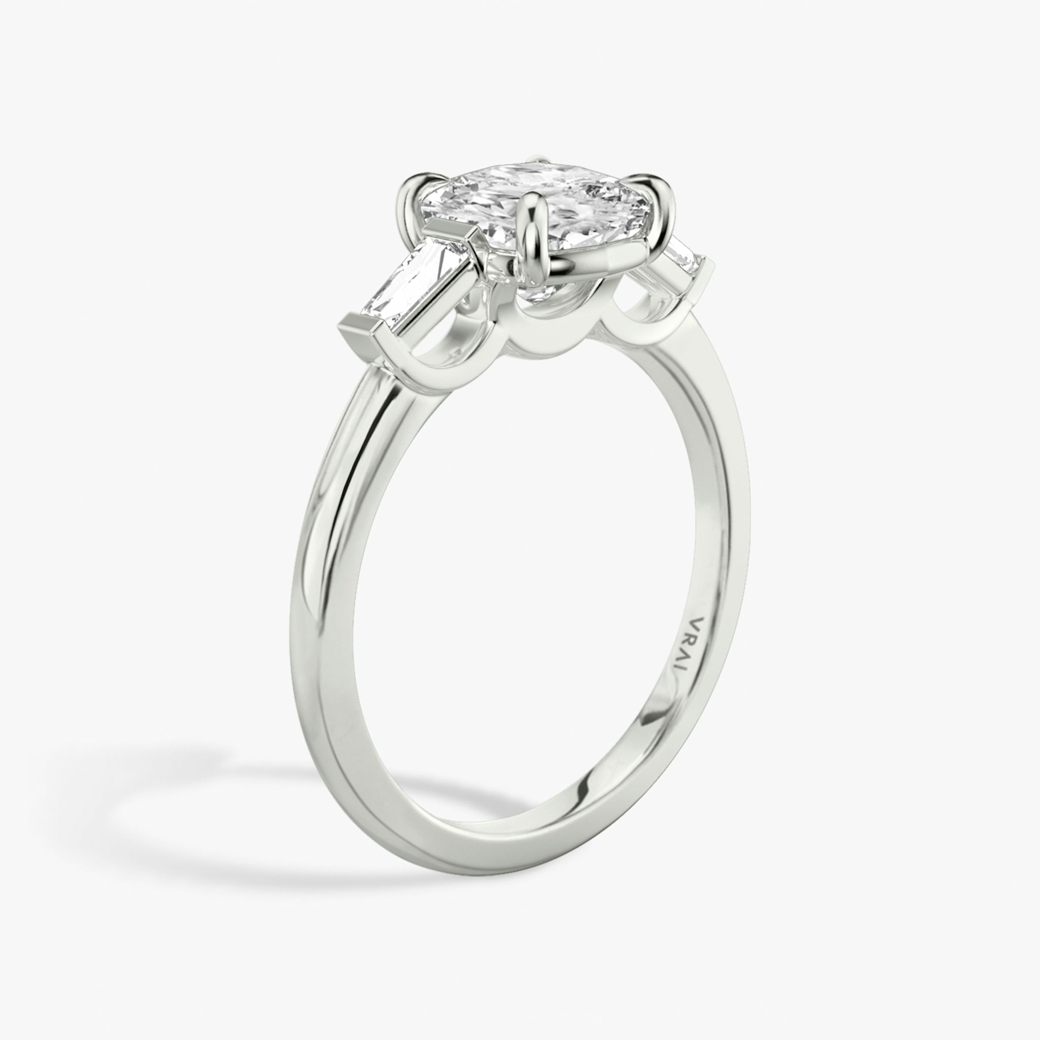 The Three Stone | Cushion | 18k | White Gold | bandAccent: Plain | sideStoneCarat: 0.10ct | sideStoneShape: Tapered Baguette | diamondOrientation: vertical | caratWeight: other