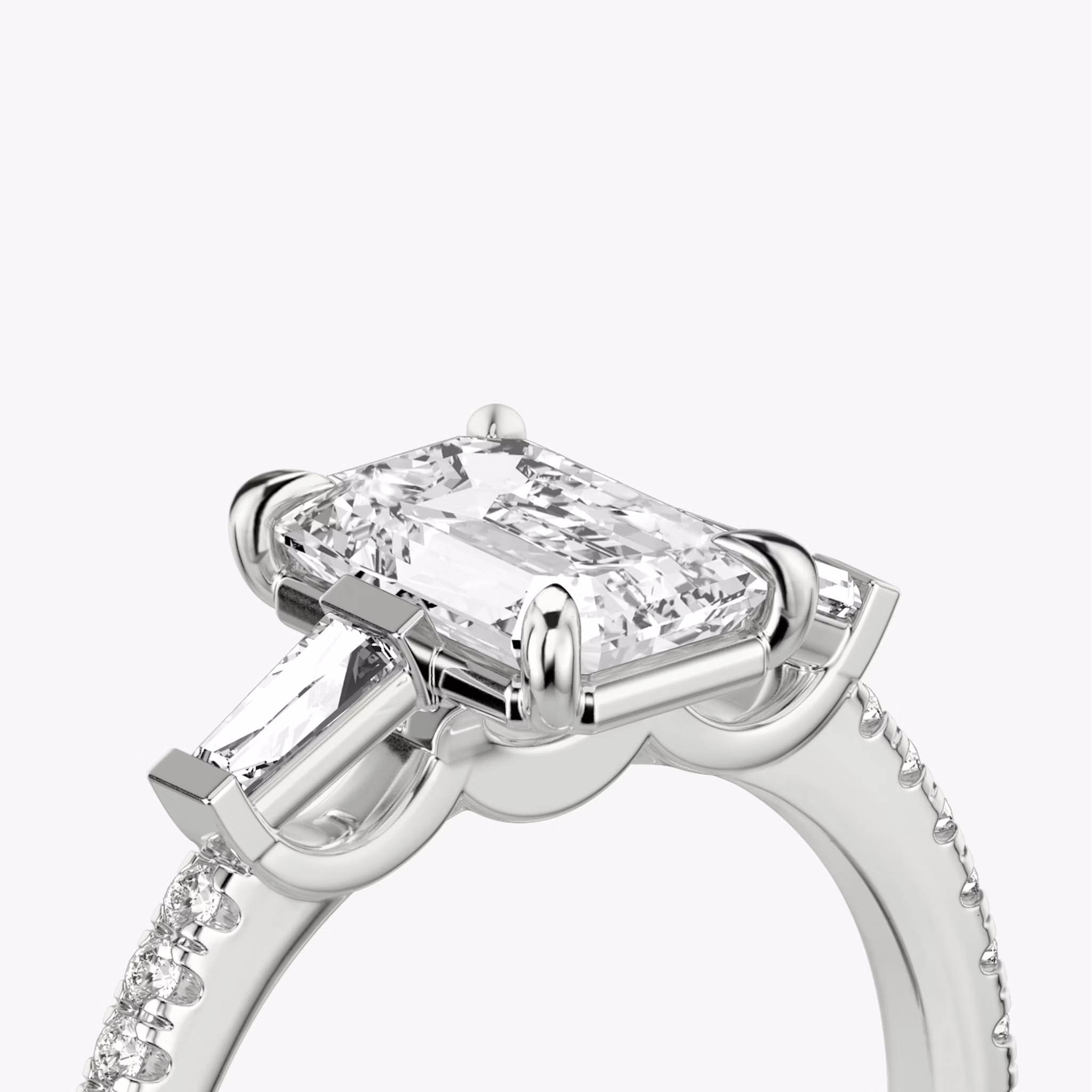 The Three Stone | Emerald | 18k | White Gold | bandAccent: Pavé | sideStoneCarat: 0.10ct | sideStoneShape: Tapered Baguette | diamondOrientation: vertical | caratWeight: other