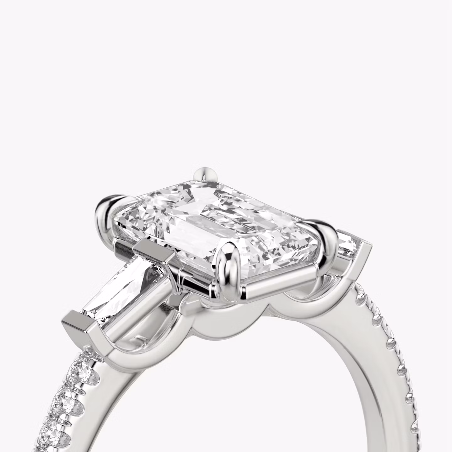 The Three Stone | Emerald | 18k | White Gold | bandAccent: Pavé | sideStoneCarat: 0.10ct | sideStoneShape: Tapered Baguette | diamondOrientation: vertical | caratWeight: other