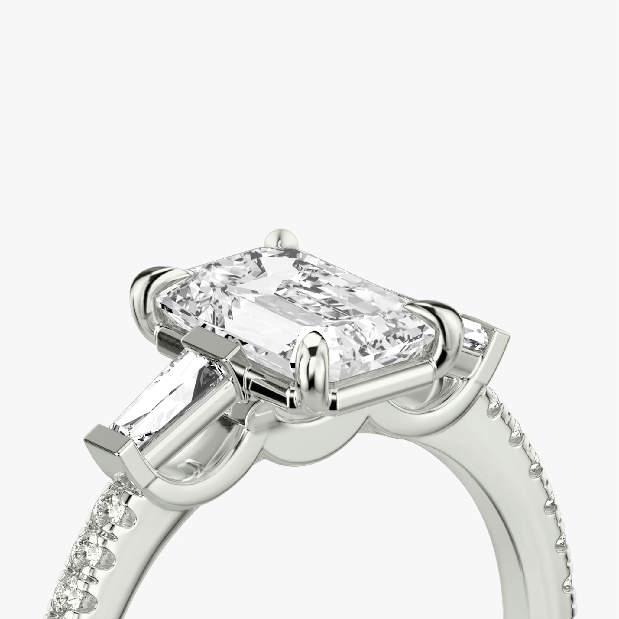 The Three Stone | Emerald | 18k | White Gold | bandAccent: Pavé | sideStoneCarat: 0.10ct | sideStoneShape: Tapered Baguette | diamondOrientation: vertical | caratWeight: other