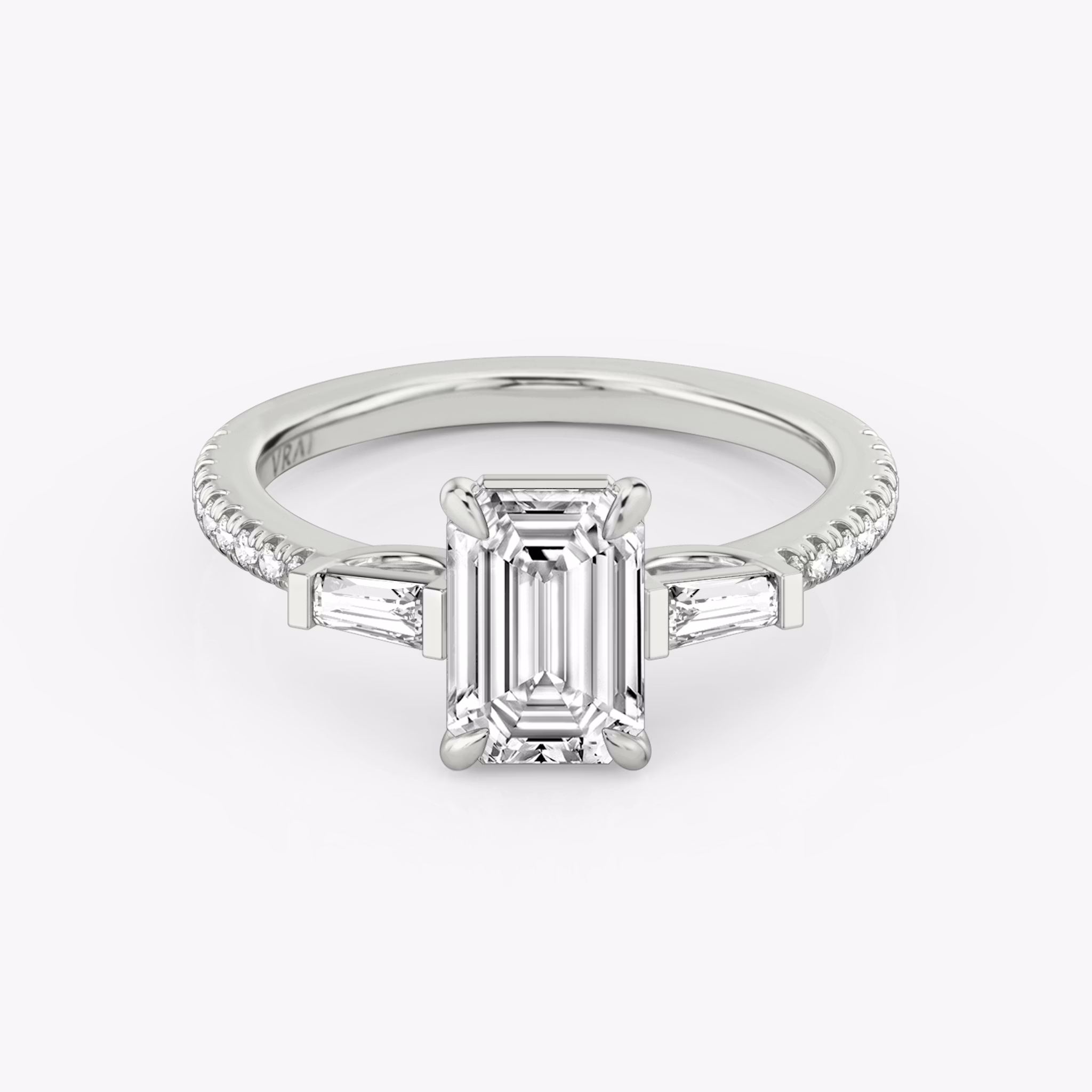 The Three Stone | Emerald | 18k | White Gold | bandAccent: Pavé | sideStoneCarat: 0.10ct | sideStoneShape: Tapered Baguette | diamondOrientation: vertical | caratWeight: other