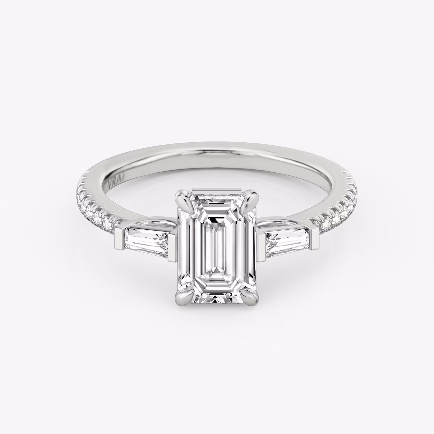 The Three Stone | Emerald | 18k | White Gold | bandAccent: Pavé | sideStoneCarat: 0.10ct | sideStoneShape: Tapered Baguette | diamondOrientation: vertical | caratWeight: other
