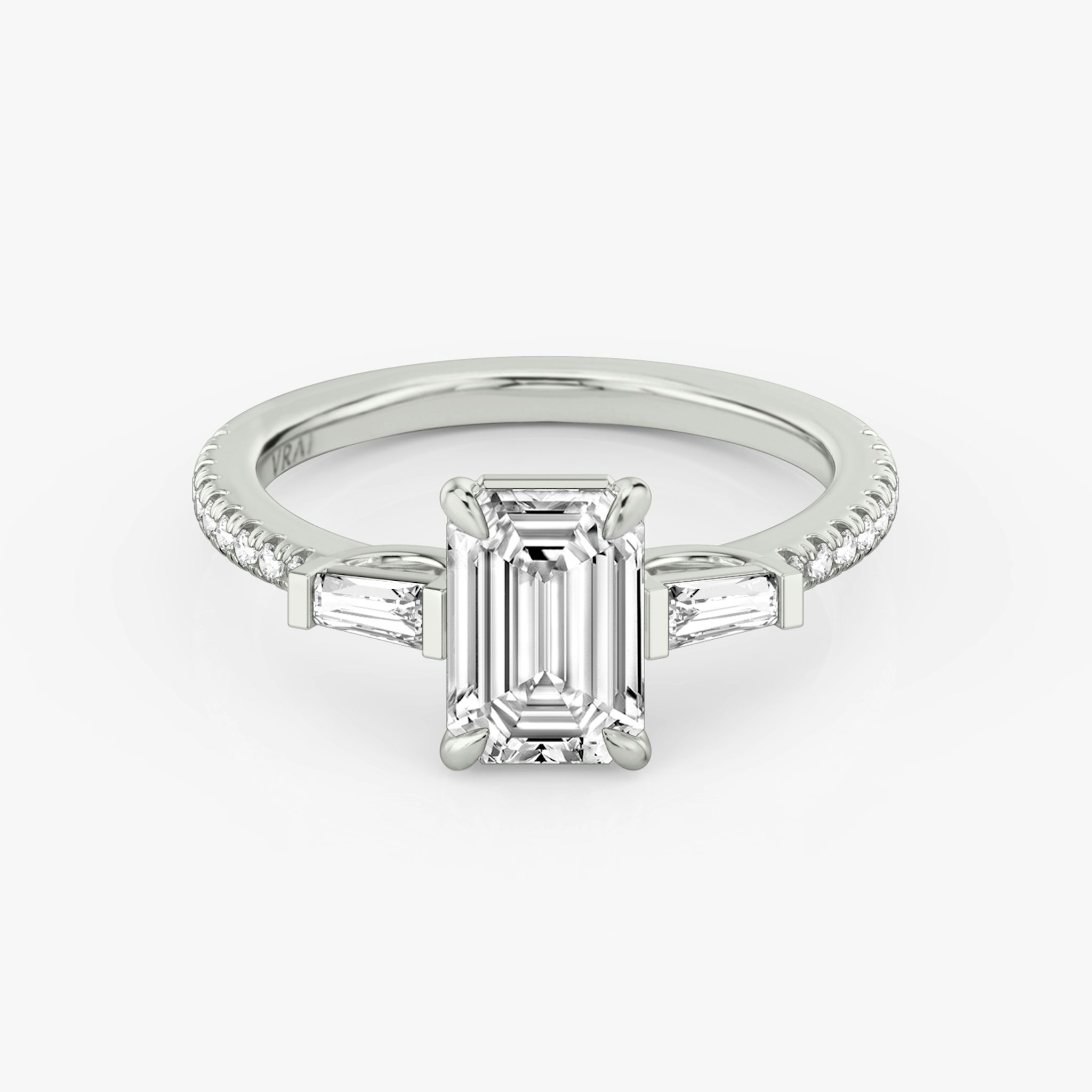 The Three Stone | Emerald | 18k | White Gold | bandAccent: Pavé | sideStoneCarat: 0.10ct | sideStoneShape: Tapered Baguette | diamondOrientation: vertical | caratWeight: other