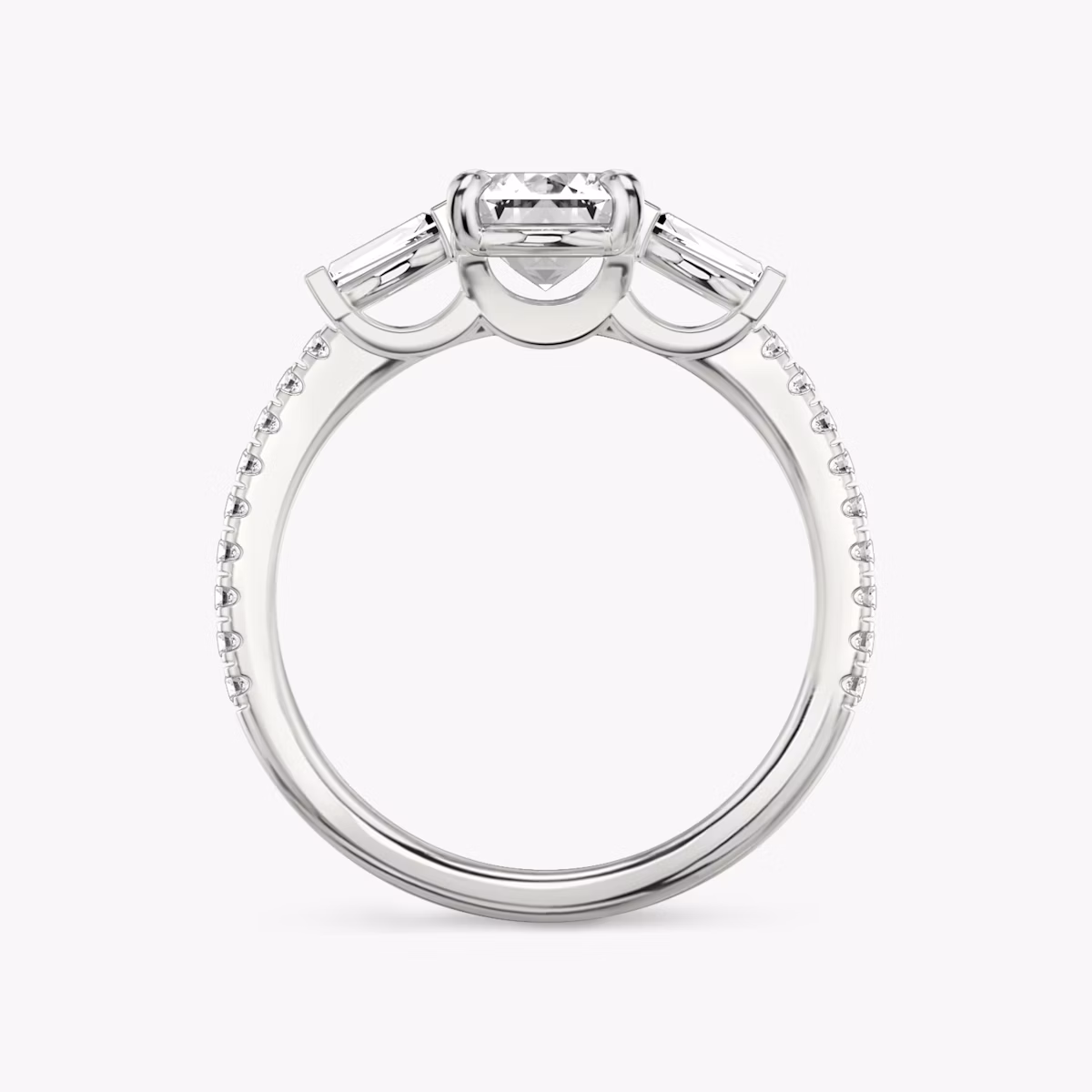 The Three Stone | Emerald | Platinum | bandAccent: Pavé | sideStoneCarat: 0.10ct | sideStoneShape: Tapered Baguette | diamondOrientation: vertical | caratWeight: other