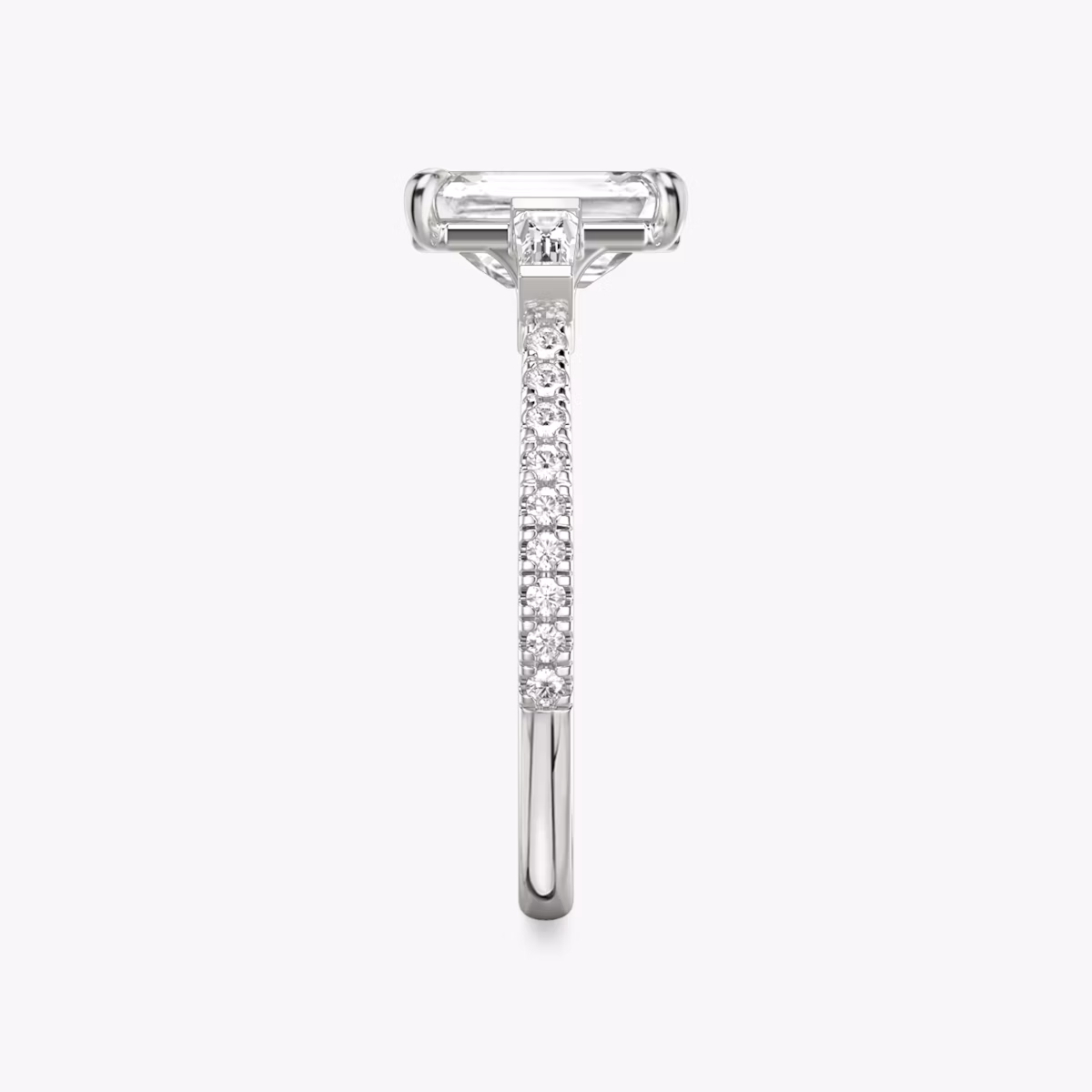 The Three Stone | Emerald | Platinum | bandAccent: Pavé | sideStoneCarat: 0.10ct | sideStoneShape: Tapered Baguette | diamondOrientation: vertical | caratWeight: other