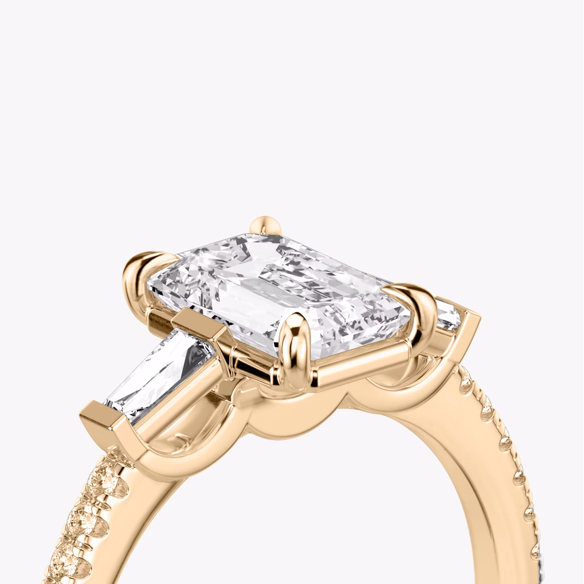 The Three Stone | Emerald | 14k | Rose Gold | bandAccent: Pavé | sideStoneCarat: 0.10ct | sideStoneShape: Tapered Baguette | diamondOrientation: vertical | caratWeight: other