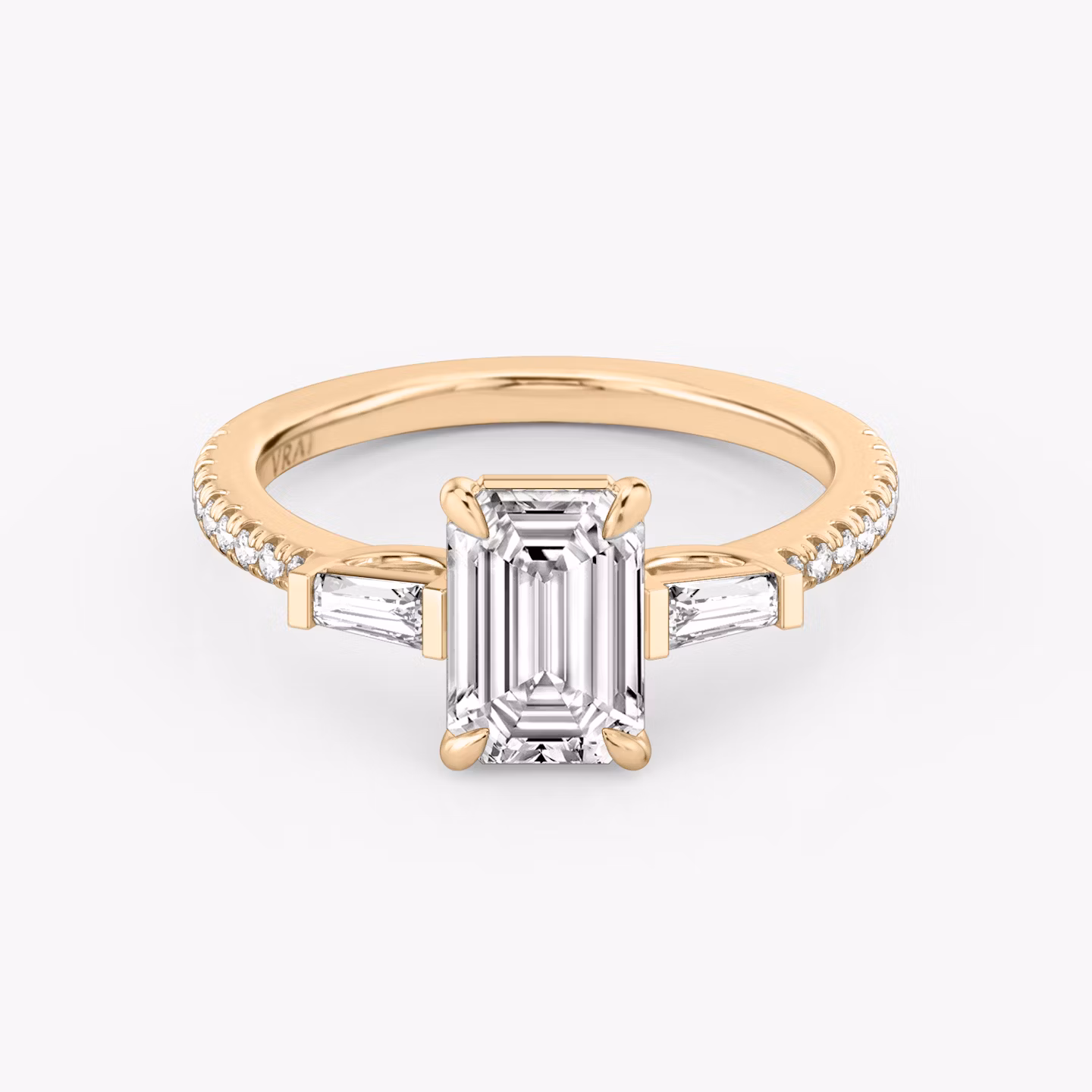 The Three Stone | Emerald | 14k | Rose Gold | bandAccent: Pavé | sideStoneCarat: 0.10ct | sideStoneShape: Tapered Baguette | diamondOrientation: vertical | caratWeight: other