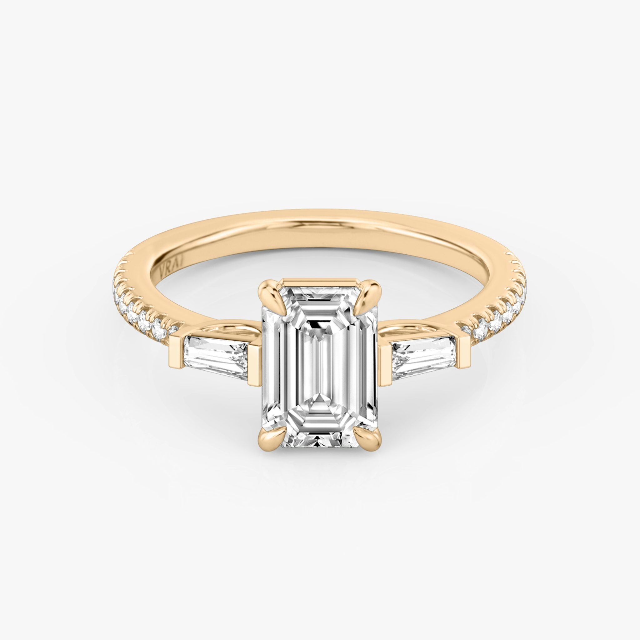 The Three Stone | Emerald | 14k | Rose Gold | bandAccent: Pavé | sideStoneCarat: 0.10ct | sideStoneShape: Tapered Baguette | diamondOrientation: vertical | caratWeight: other