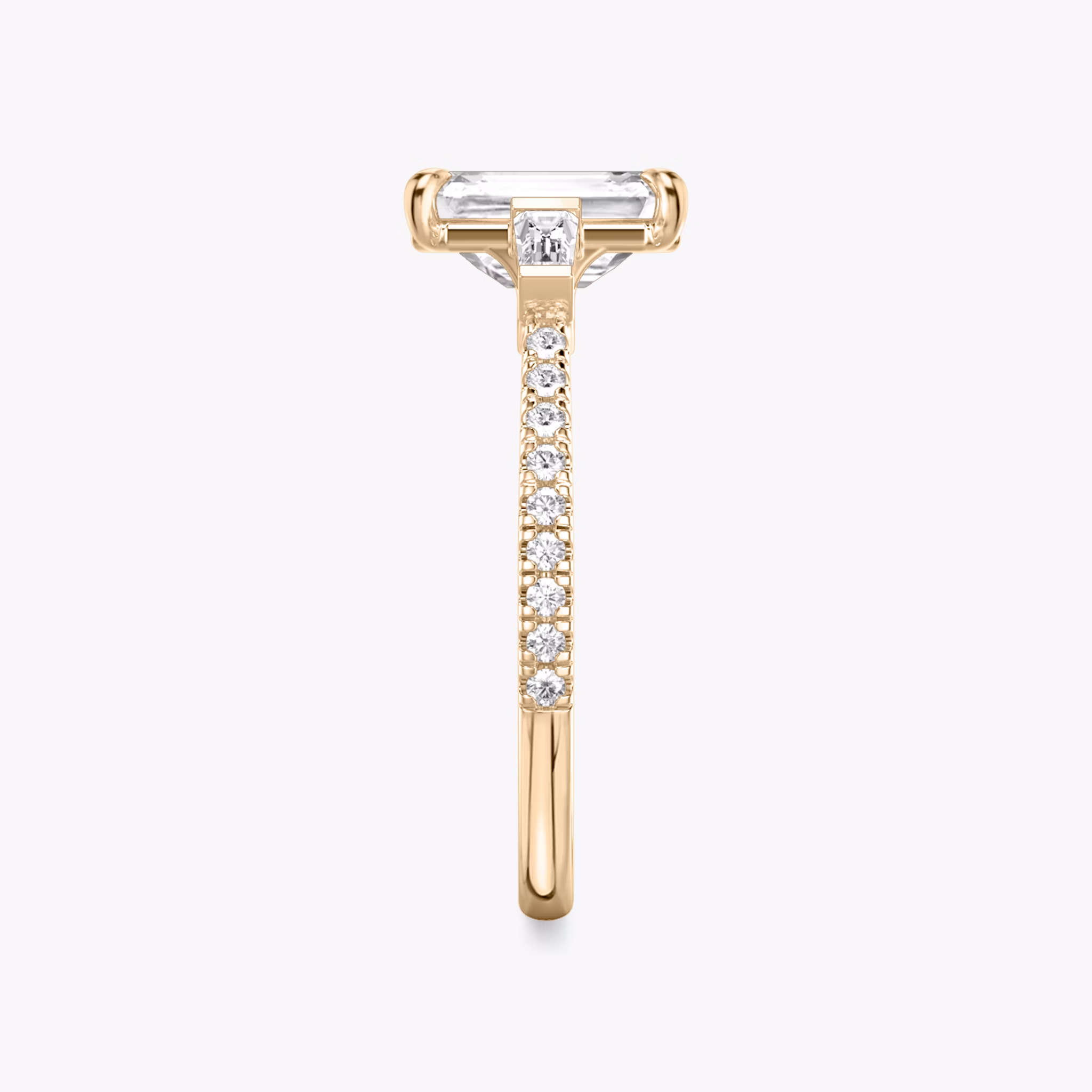 The Three Stone | Emerald | 14k | Rose Gold | bandAccent: Pavé | sideStoneCarat: 0.10ct | sideStoneShape: Tapered Baguette | diamondOrientation: vertical | caratWeight: other