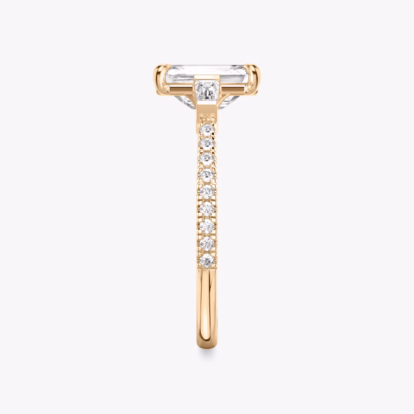 The Three Stone | Emerald | 14k | Rose Gold | bandAccent: Pavé | sideStoneCarat: 0.10ct | sideStoneShape: Tapered Baguette | diamondOrientation: vertical | caratWeight: other