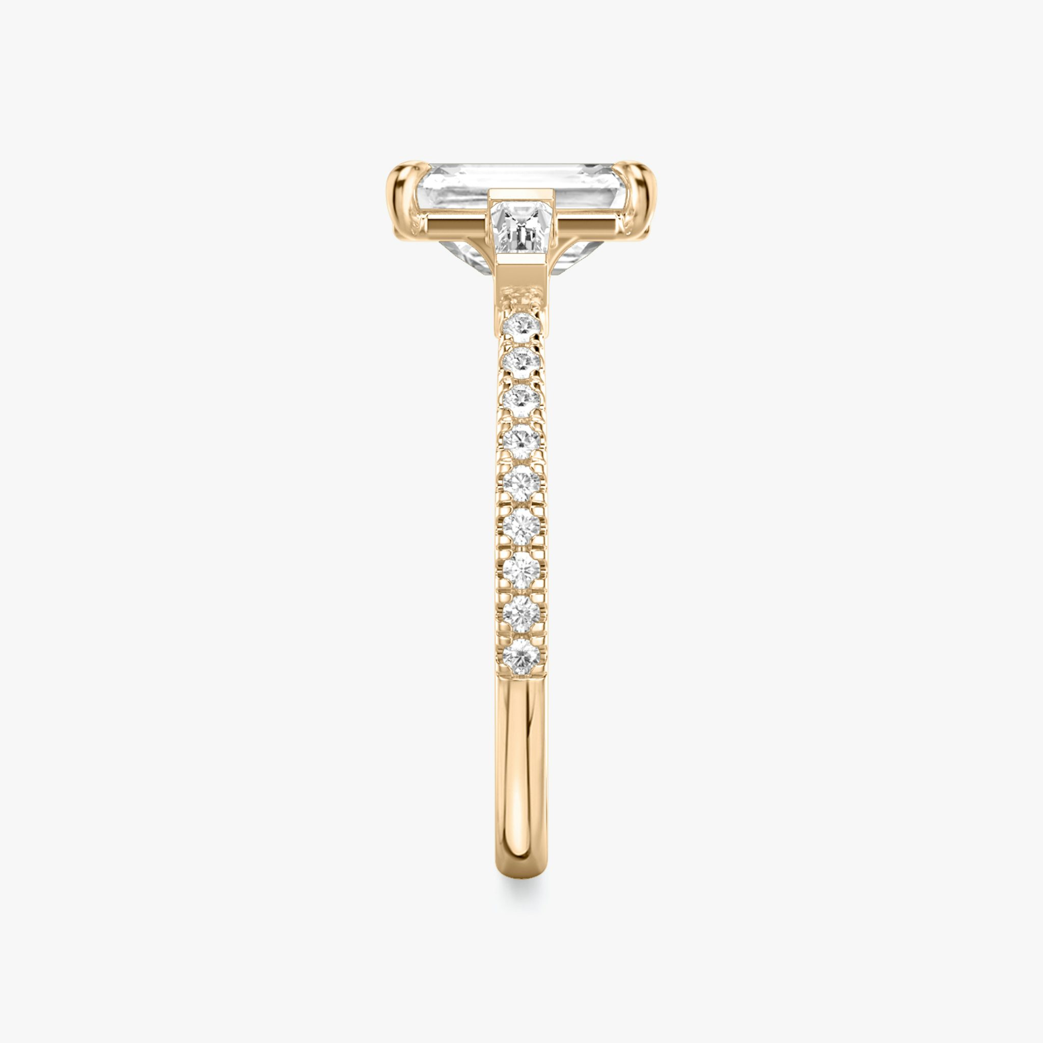 The Three Stone | Emerald | 14k | Rose Gold | bandAccent: Pavé | sideStoneCarat: 0.10ct | sideStoneShape: Tapered Baguette | diamondOrientation: vertical | caratWeight: other