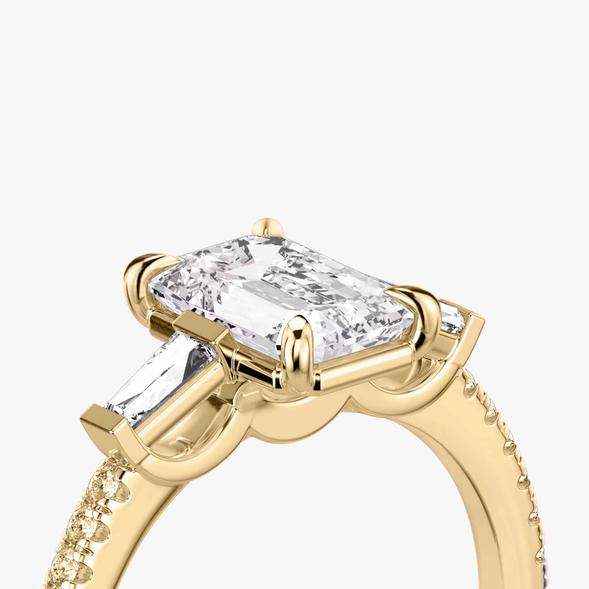 The Three Stone | Emerald | 18k | Yellow Gold | bandAccent: Pavé | sideStoneCarat: 0.10ct | sideStoneShape: Tapered Baguette | diamondOrientation: vertical | caratWeight: other