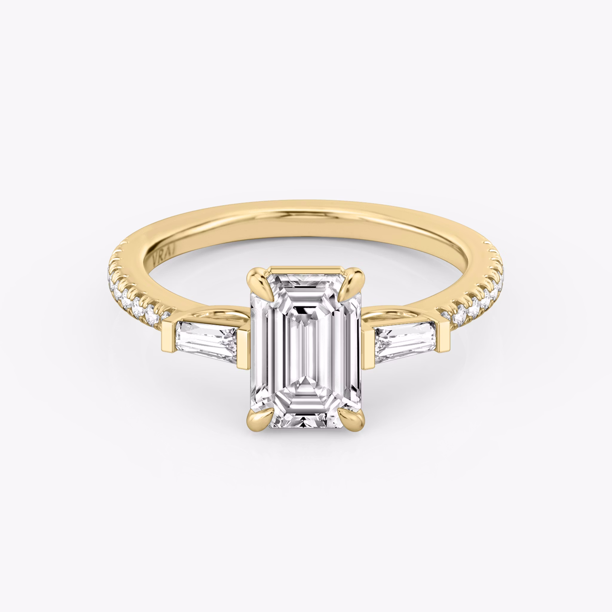The Three Stone | Emerald | 18k | Yellow Gold | bandAccent: Pavé | sideStoneCarat: 0.10ct | sideStoneShape: Tapered Baguette | diamondOrientation: vertical | caratWeight: other
