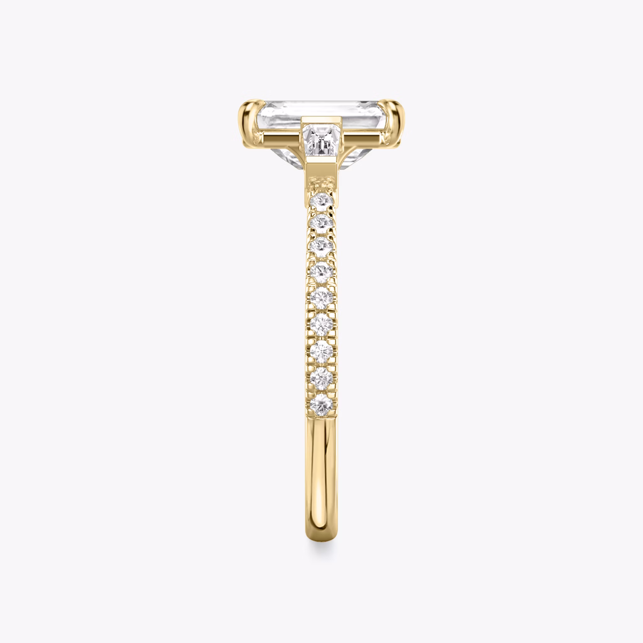 The Three Stone | Emerald | 18k | Yellow Gold | bandAccent: Pavé | sideStoneCarat: 0.10ct | sideStoneShape: Tapered Baguette | diamondOrientation: vertical | caratWeight: other