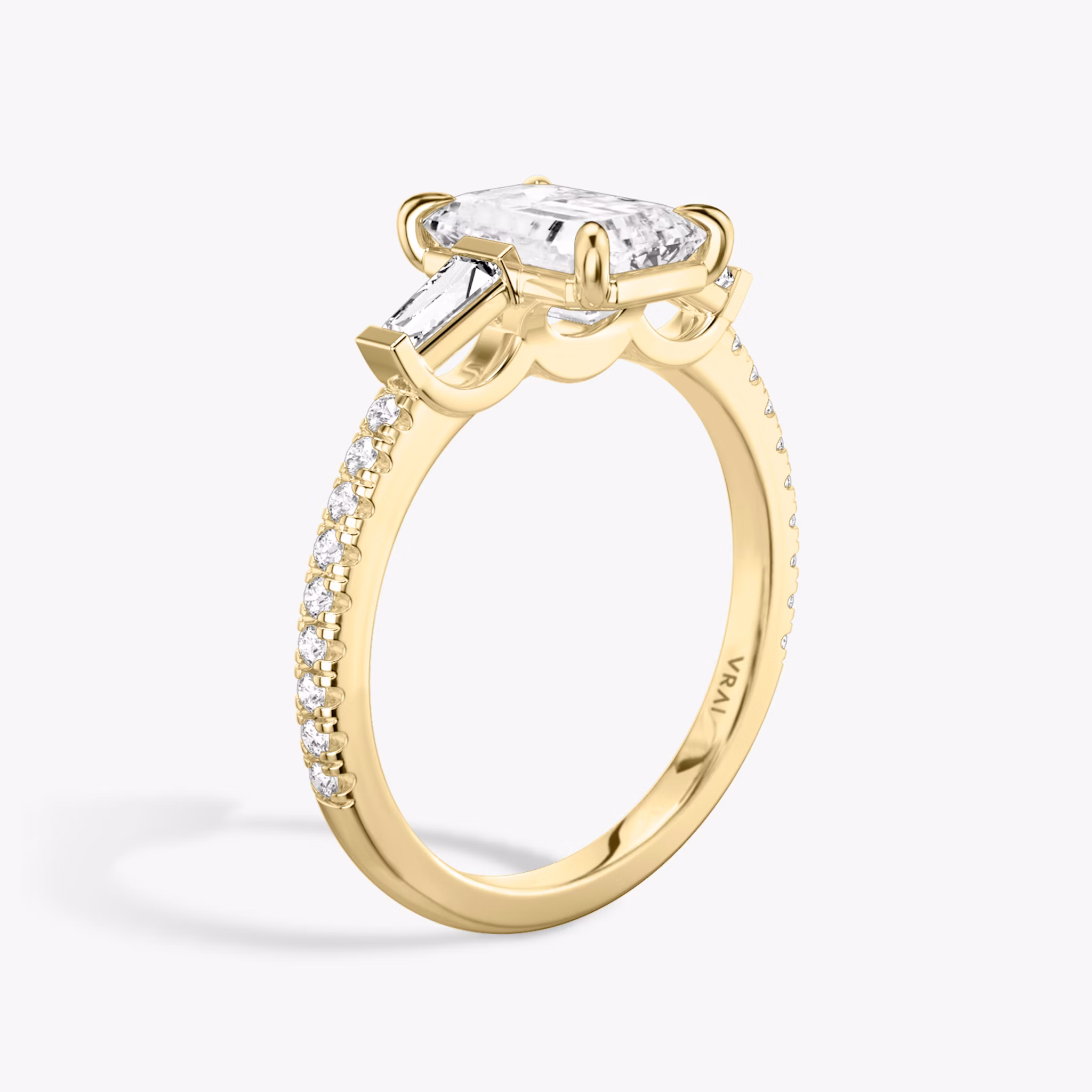 The Three Stone | Emerald | 18k | Yellow Gold | bandAccent: Pavé | sideStoneCarat: 0.10ct | sideStoneShape: Tapered Baguette | diamondOrientation: vertical | caratWeight: other