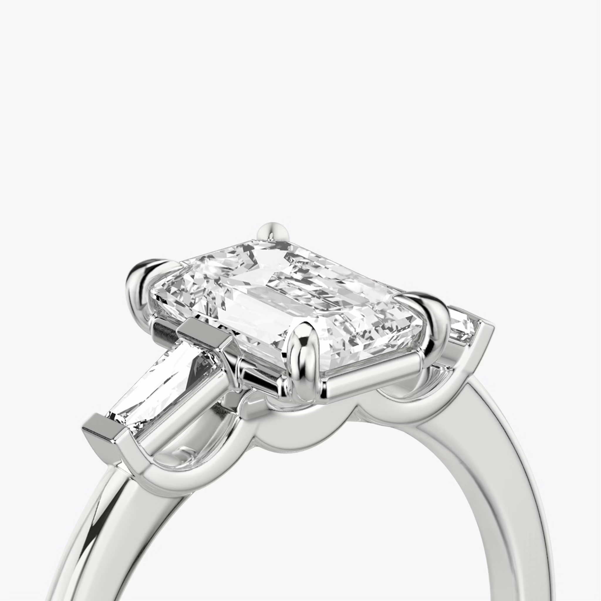 The Three Stone | Emerald | Platinum | bandAccent: Plain | sideStoneCarat: 0.10ct | sideStoneShape: Tapered Baguette | diamondOrientation: vertical | caratWeight: other