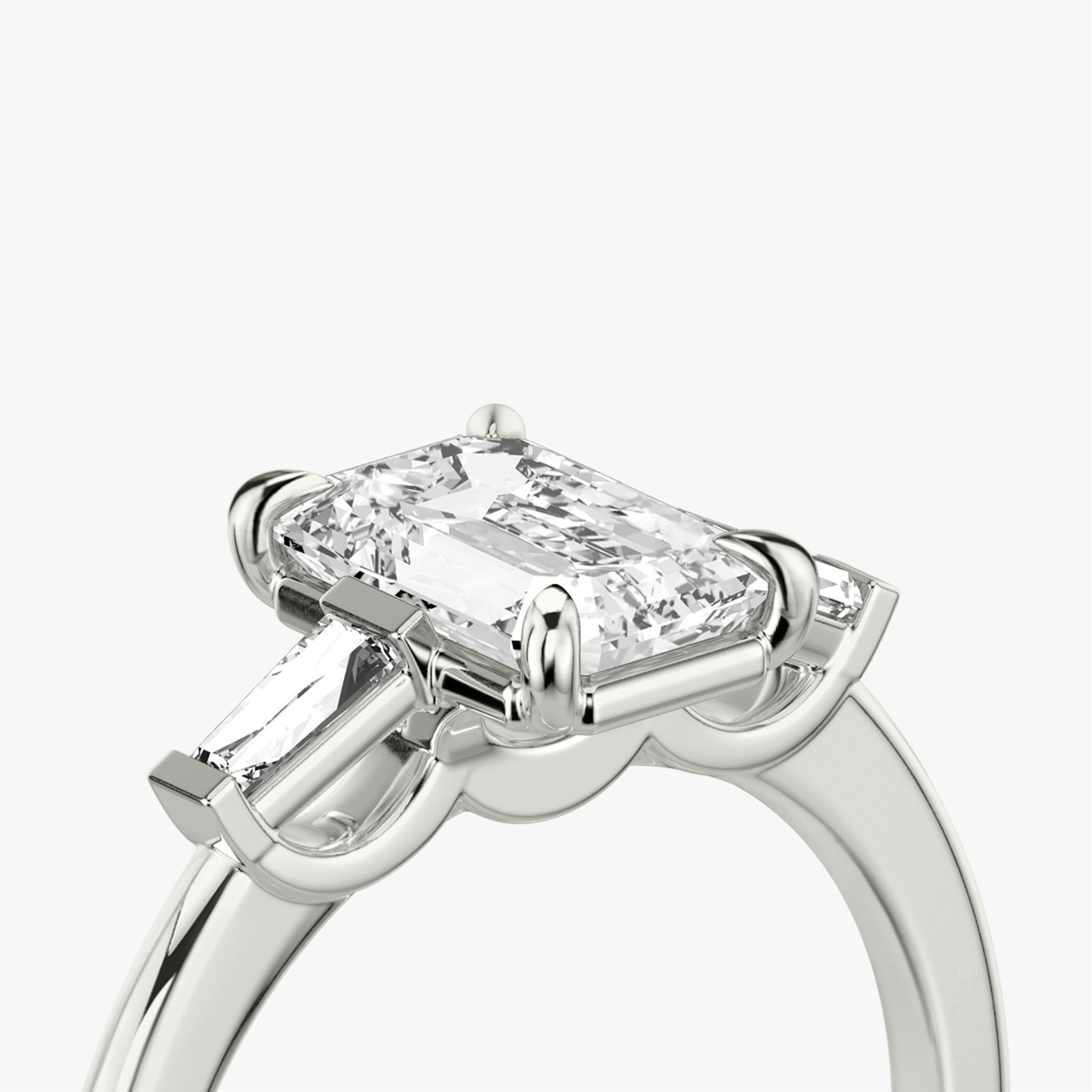 The Three Stone | Emerald | Platinum | bandAccent: Plain | sideStoneCarat: 0.10ct | sideStoneShape: Tapered Baguette | diamondOrientation: vertical | caratWeight: other