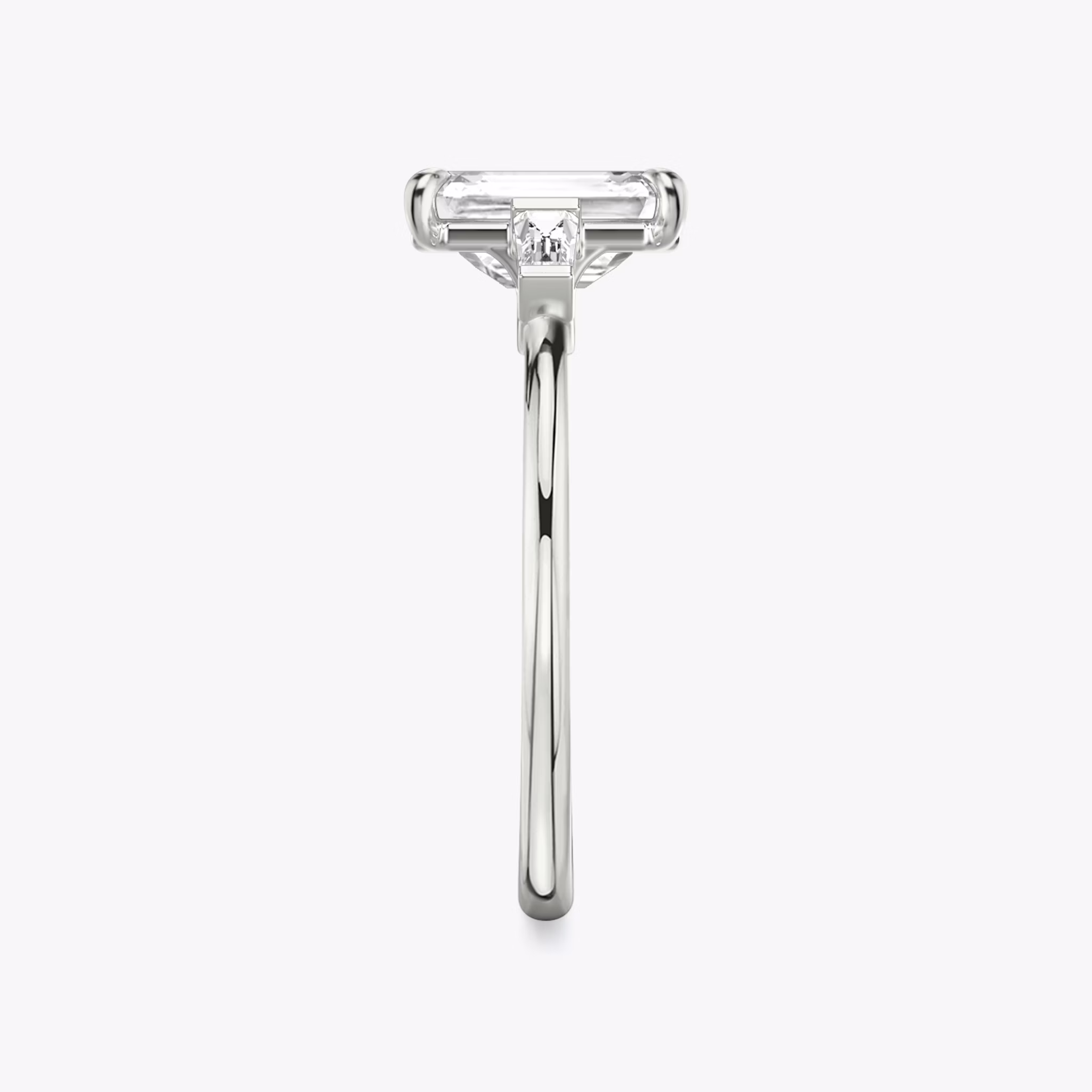 The Three Stone | Emerald | Platinum | bandAccent: Plain | sideStoneCarat: 0.10ct | sideStoneShape: Tapered Baguette | diamondOrientation: vertical | caratWeight: other