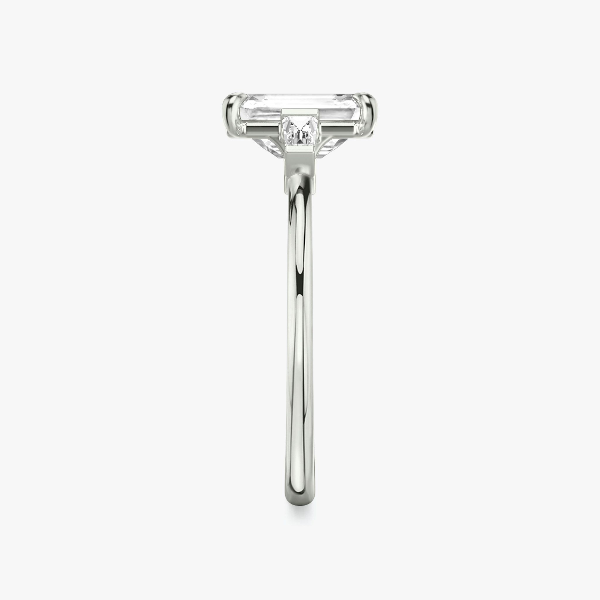 The Three Stone | Emerald | Platinum | bandAccent: Plain | sideStoneCarat: 0.10ct | sideStoneShape: Tapered Baguette | diamondOrientation: vertical | caratWeight: other