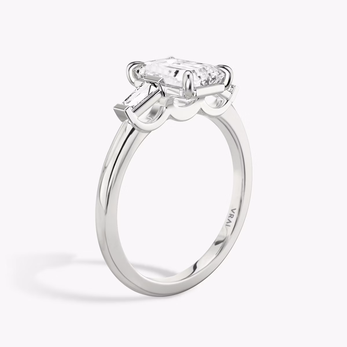 The Three Stone | Emerald | Platinum | bandAccent: Plain | sideStoneCarat: 0.10ct | sideStoneShape: Tapered Baguette | diamondOrientation: vertical | caratWeight: other