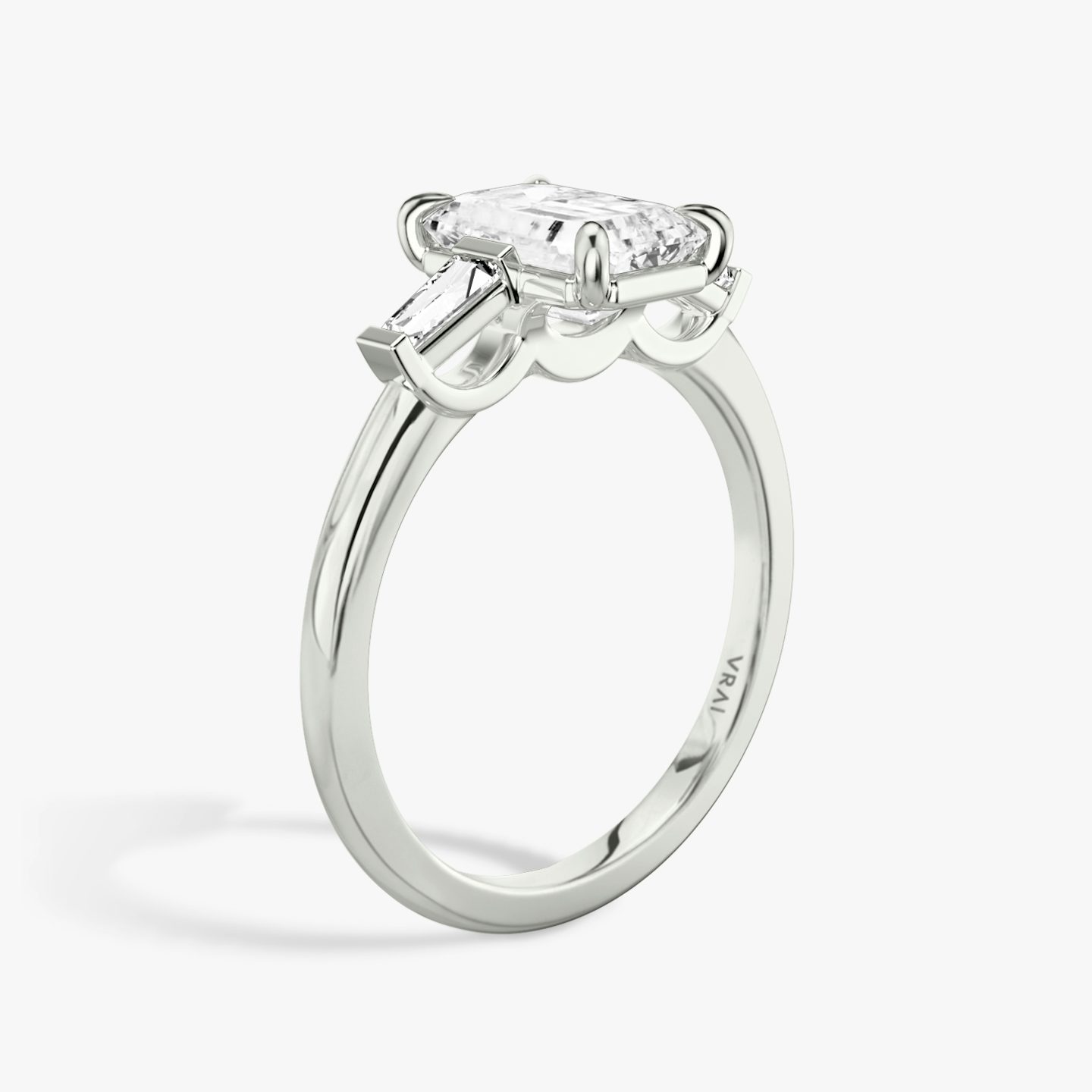 The Three Stone | Emerald | Platinum | bandAccent: Plain | sideStoneCarat: 0.10ct | sideStoneShape: Tapered Baguette | diamondOrientation: vertical | caratWeight: other