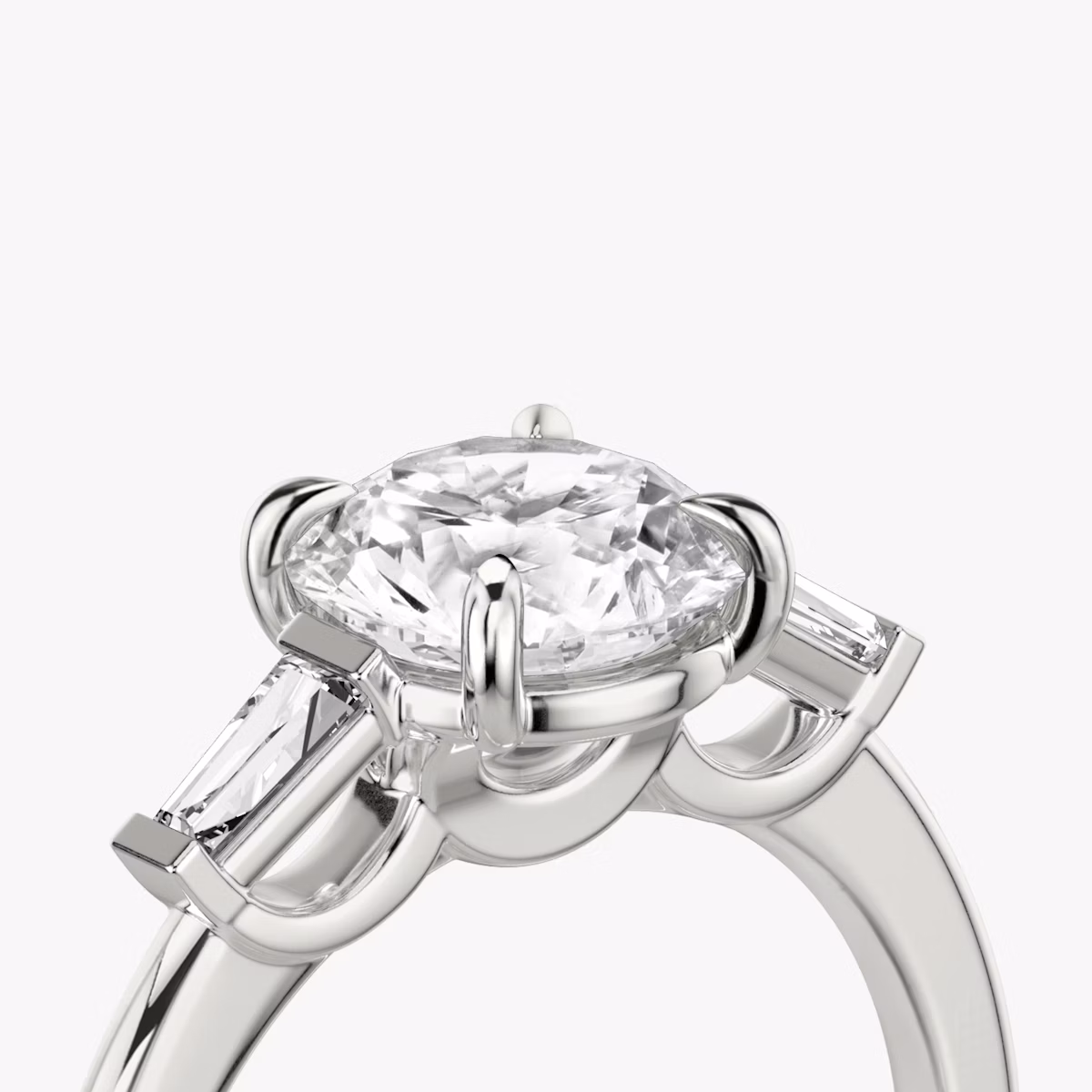 The Three Stone | Round Brilliant | Platinum | bandAccent: Plain | caratWeight: other | sideStoneCarat: 0.10ct | sideStoneShape: Tapered Baguette | diamondOrientation: vertical