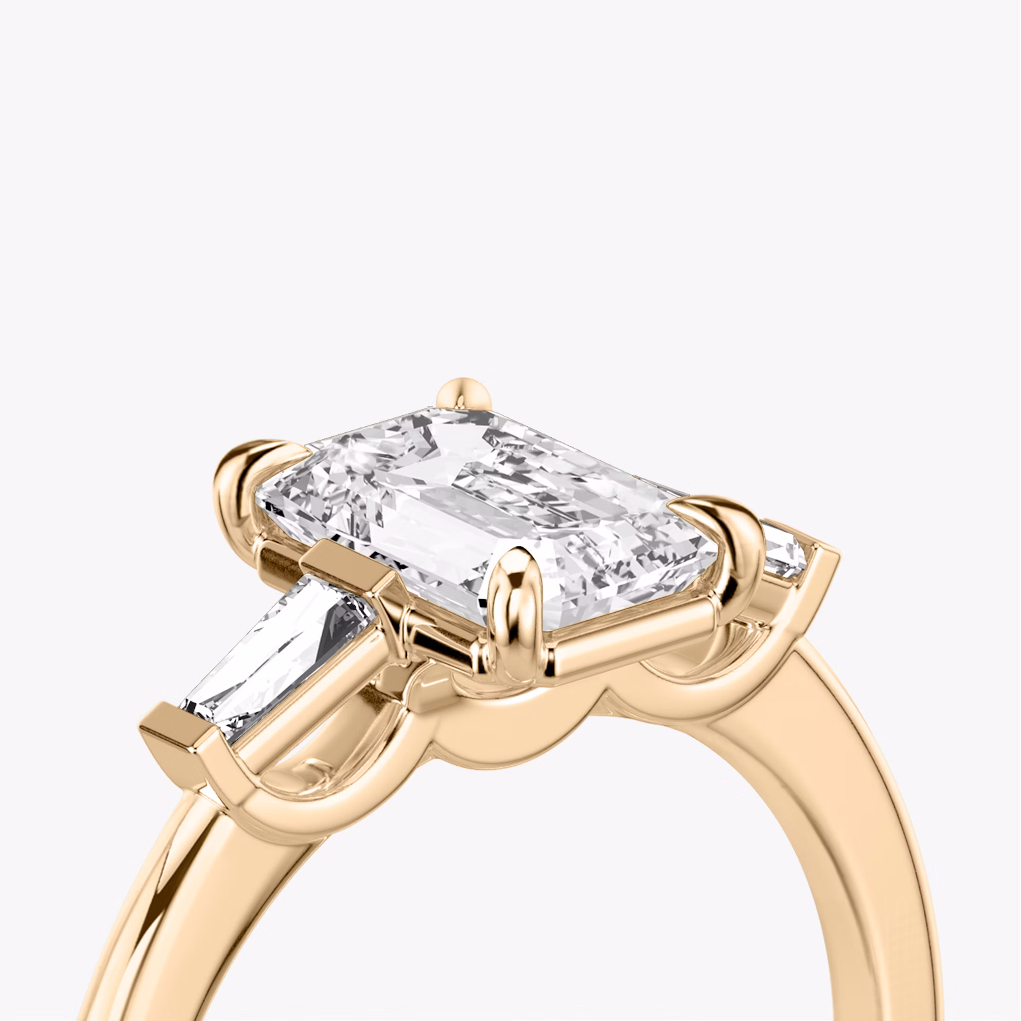 The Three Stone | Emerald | 14k | Rose Gold | bandAccent: Plain | sideStoneCarat: 0.10ct | sideStoneShape: Tapered Baguette | diamondOrientation: vertical | caratWeight: other