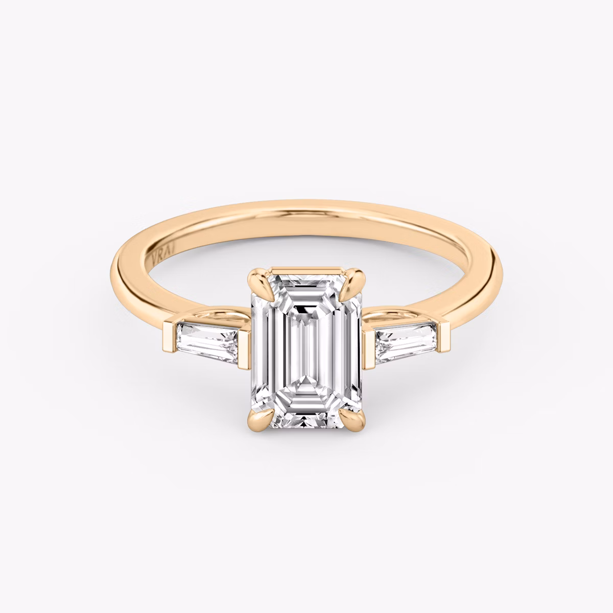 The Three Stone | Emerald | 14k | Rose Gold | bandAccent: Plain | sideStoneCarat: 0.10ct | sideStoneShape: Tapered Baguette | diamondOrientation: vertical | caratWeight: other