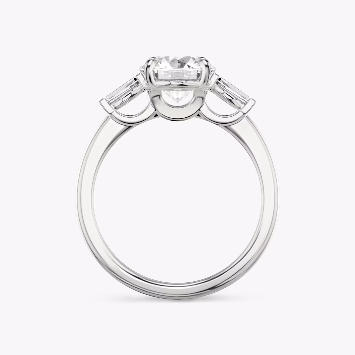 The Three Stone | Round Brilliant | Platinum | bandAccent: Plain | caratWeight: other | sideStoneCarat: 0.10ct | sideStoneShape: Tapered Baguette | diamondOrientation: vertical