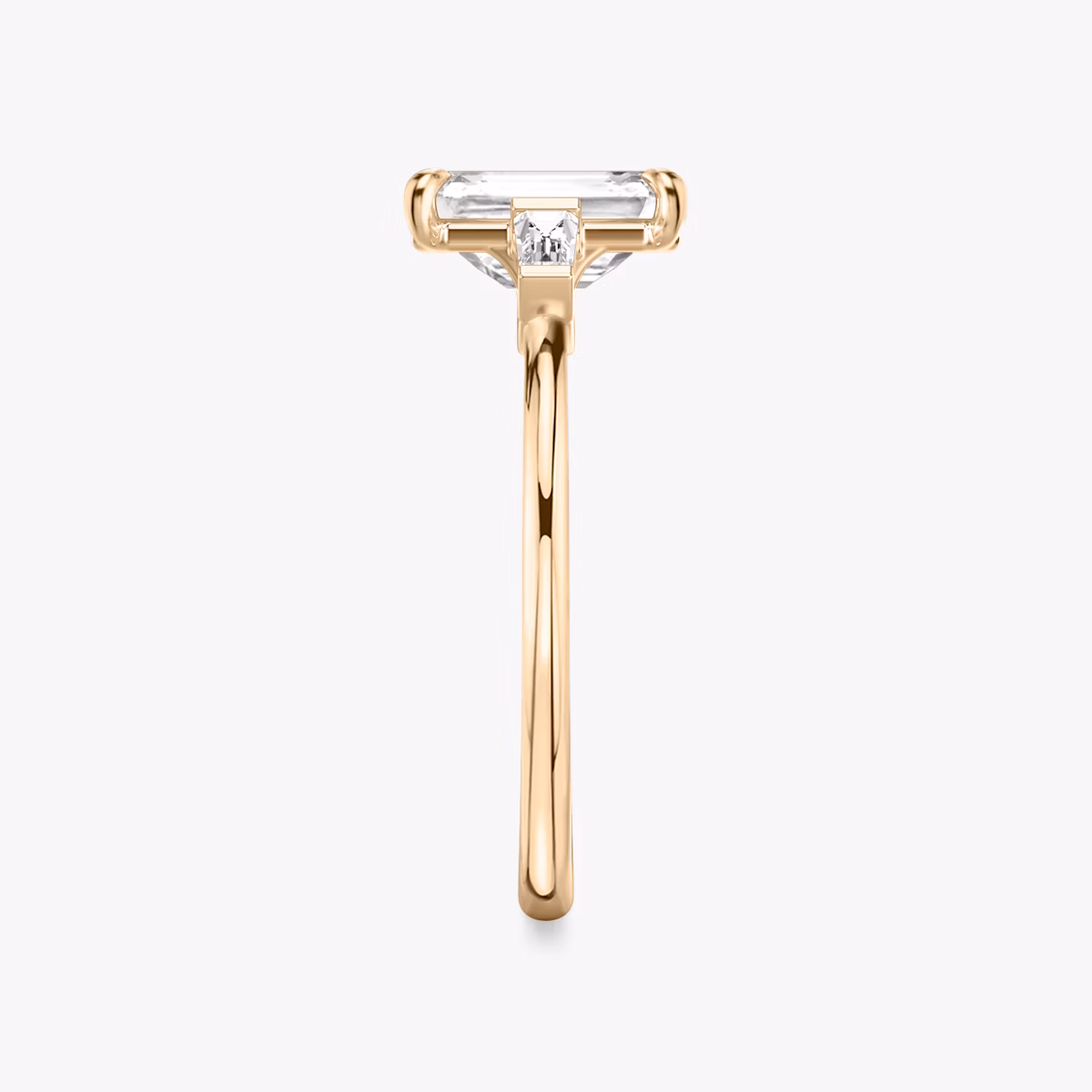 The Three Stone | Emerald | 14k | Rose Gold | bandAccent: Plain | sideStoneCarat: 0.10ct | sideStoneShape: Tapered Baguette | diamondOrientation: vertical | caratWeight: other