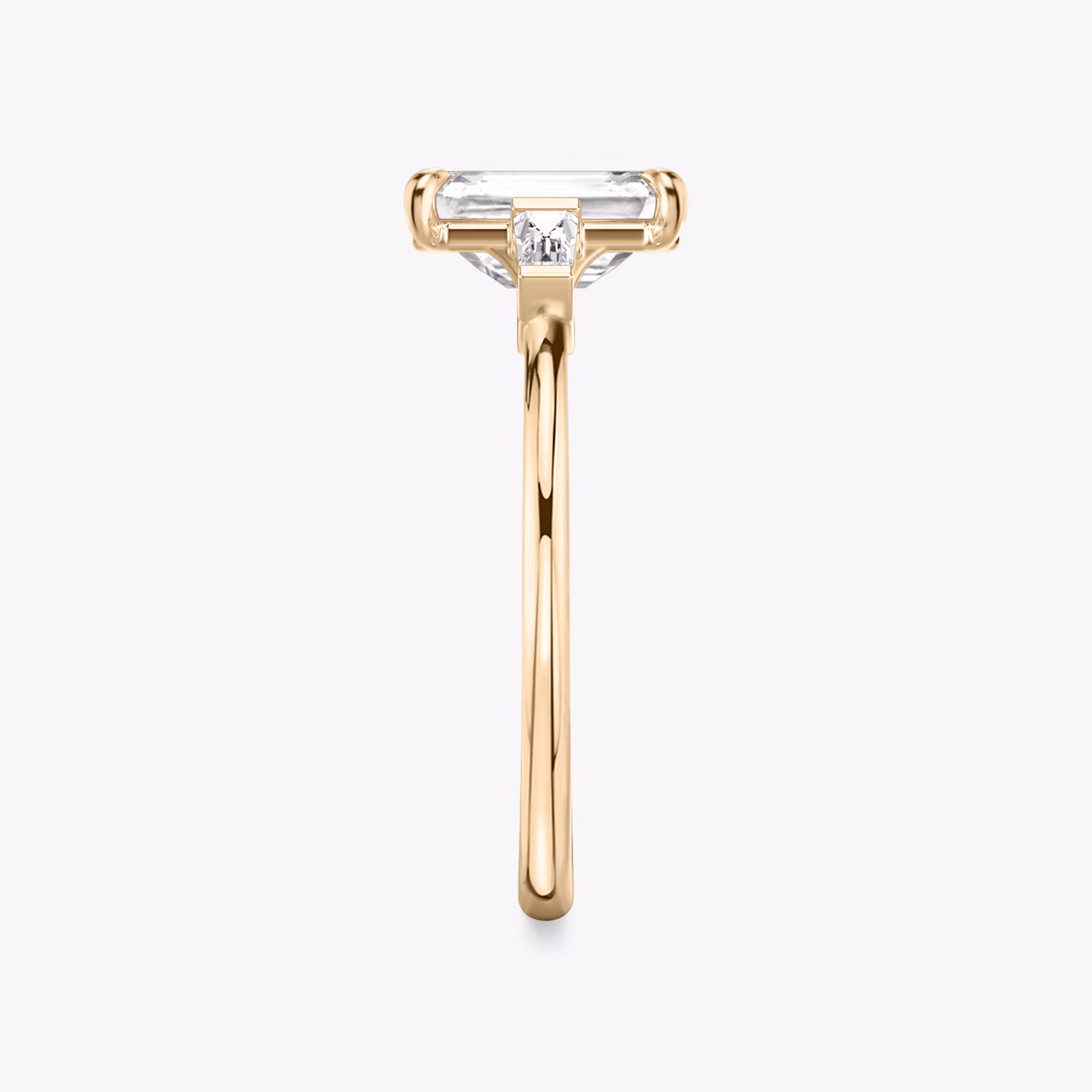 The Three Stone | Emerald | 14k | Rose Gold | bandAccent: Plain | sideStoneCarat: 0.10ct | sideStoneShape: Tapered Baguette | diamondOrientation: vertical | caratWeight: other