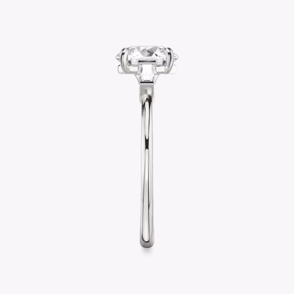 The Three Stone | Round Brilliant | Platinum | bandAccent: Plain | caratWeight: other | sideStoneCarat: 0.10ct | sideStoneShape: Tapered Baguette | diamondOrientation: vertical