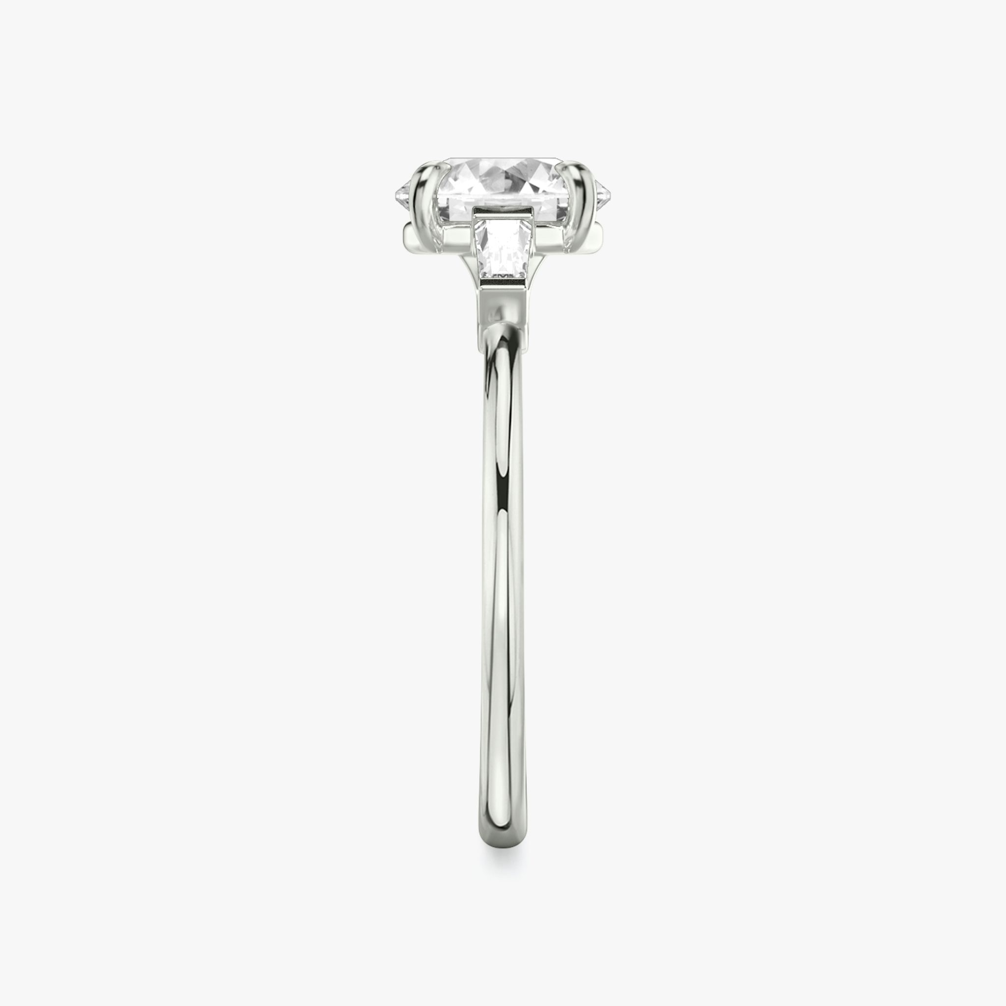 The Three Stone | Round Brilliant | 18k | White Gold | bandAccent: Plain | caratWeight: other | sideStoneCarat: 0.10ct | sideStoneShape: Tapered Baguette | diamondOrientation: vertical