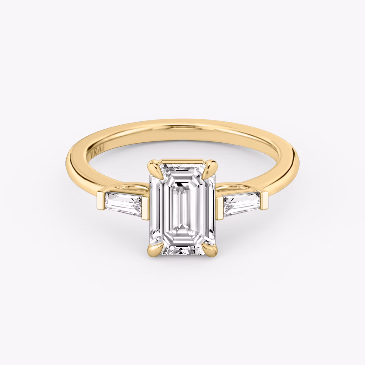 The Three Stone | Emerald | 18k | Yellow Gold | bandAccent: Plain | sideStoneCarat: 0.10ct | sideStoneShape: Tapered Baguette | diamondOrientation: vertical | caratWeight: other